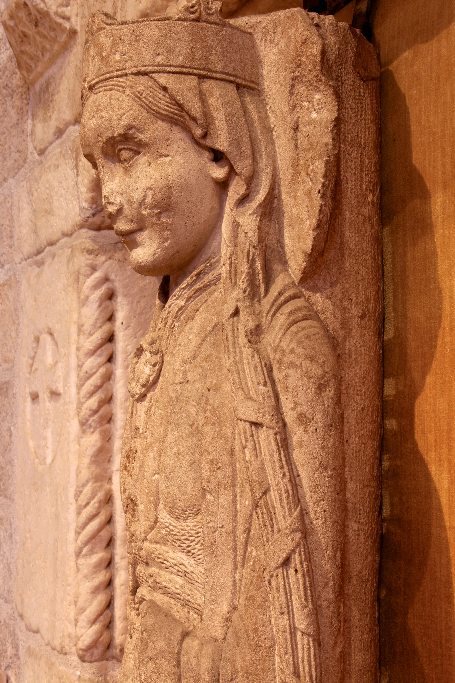 Figure 3: The back of the figure is attached to a round column. Her long hair is bound into braids.
