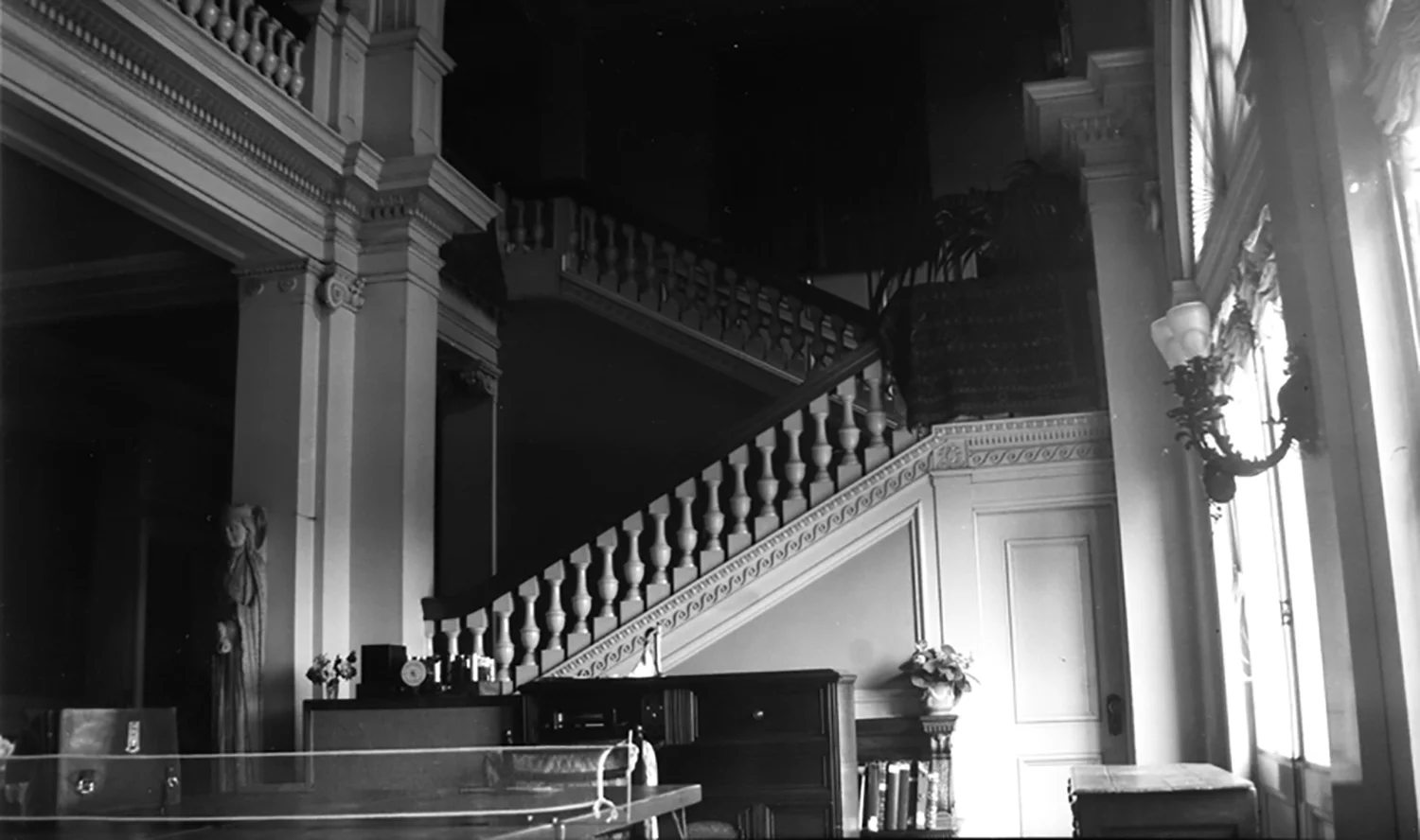 Figure 10: The twelfth-century statue-column, thought to represent the Queen of Sheba, was displayed in Cairnwood's parlor hall in the 1930s. Here the figure is tied to a column with a piece of wire, just behind a ping-pong table. Photo: Glencairn Museum Archives.