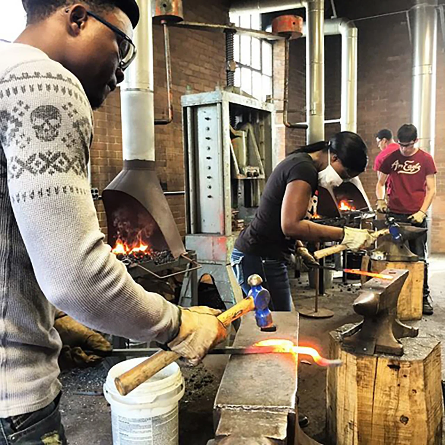 Figure 5: Bryn Athyn College students working on their projects in the Bryn Athyn metalwork studio. Photograph by Warren Holzman.