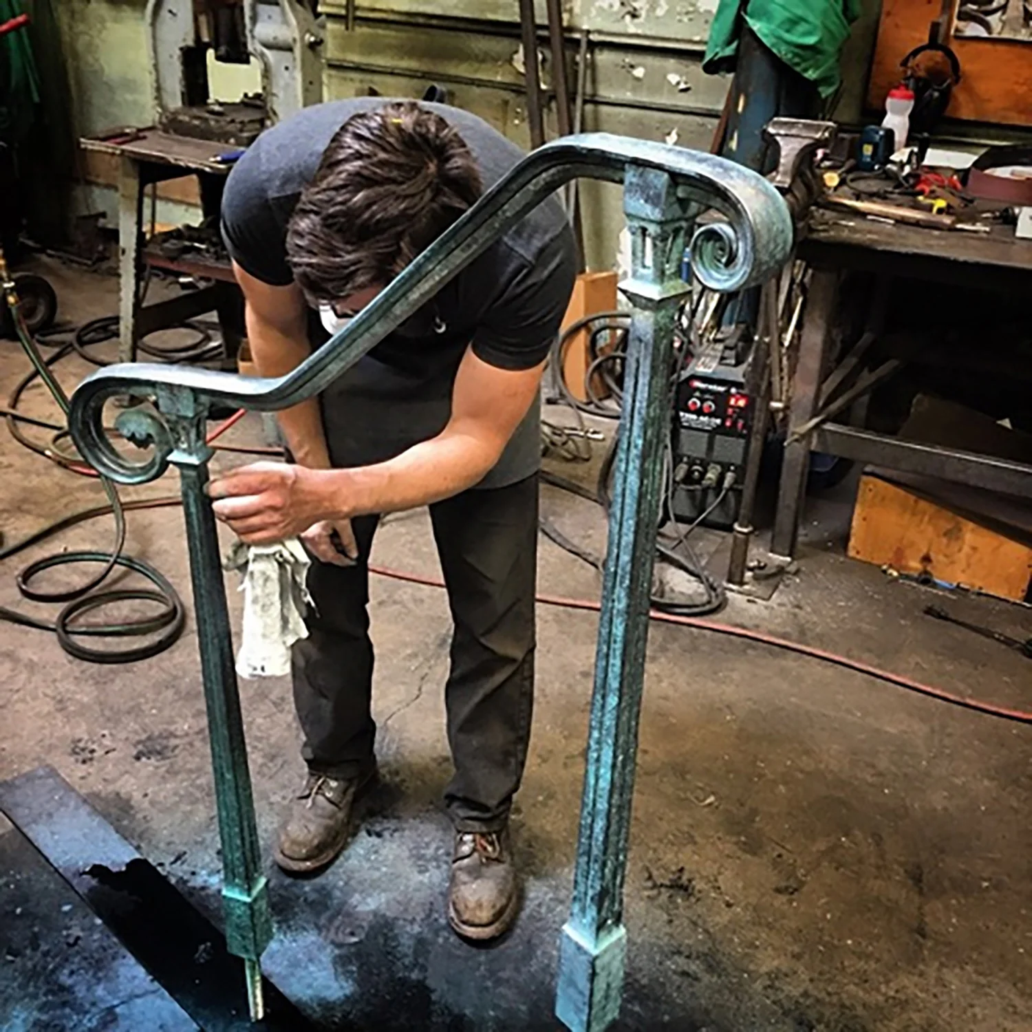 Figure 18: Warren Holzman doing final work on a new railing for Glencairn in the Iron Studio shop. Two railings were made from stainless steel, finished to resemble Monel, for Glencairn’s front steps. Photograph courtesy of Warren Holzman.