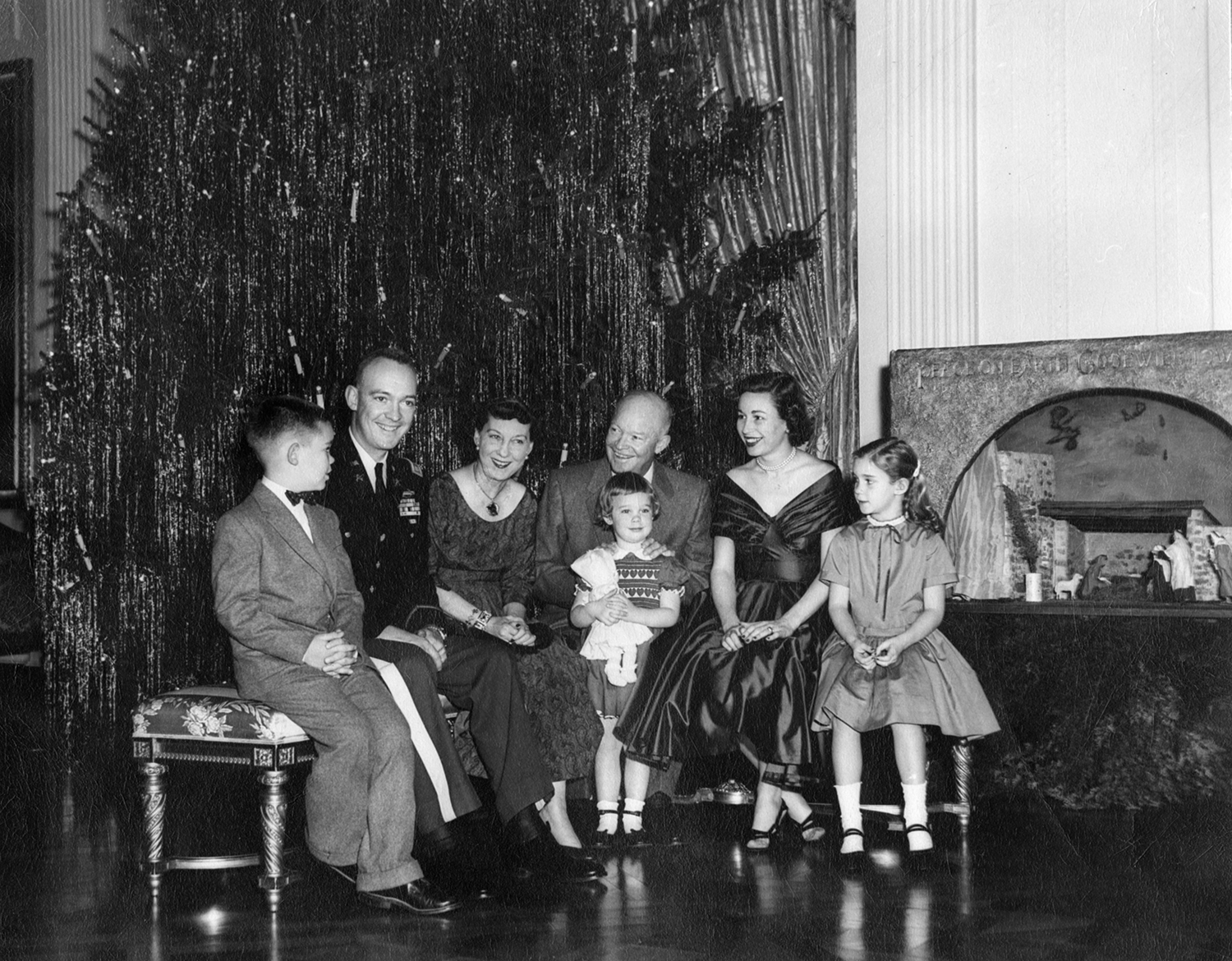 Christmas 1955. From left to right, David Eisenhower, John Eisenhower, First Lady Mamie Eisenhower, President Dwight Eisenhower, Susan Eisenhower, Barbara Eisenhower, and Anne Eisenhower. Photo courtesy of the National Park Service (Abbie Rowe).