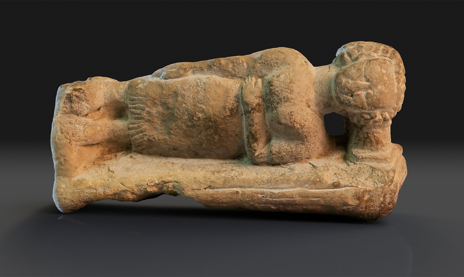 Limestone figure of a sleeping woman using a headrest in the collection of Glencairn Museum (E1219).