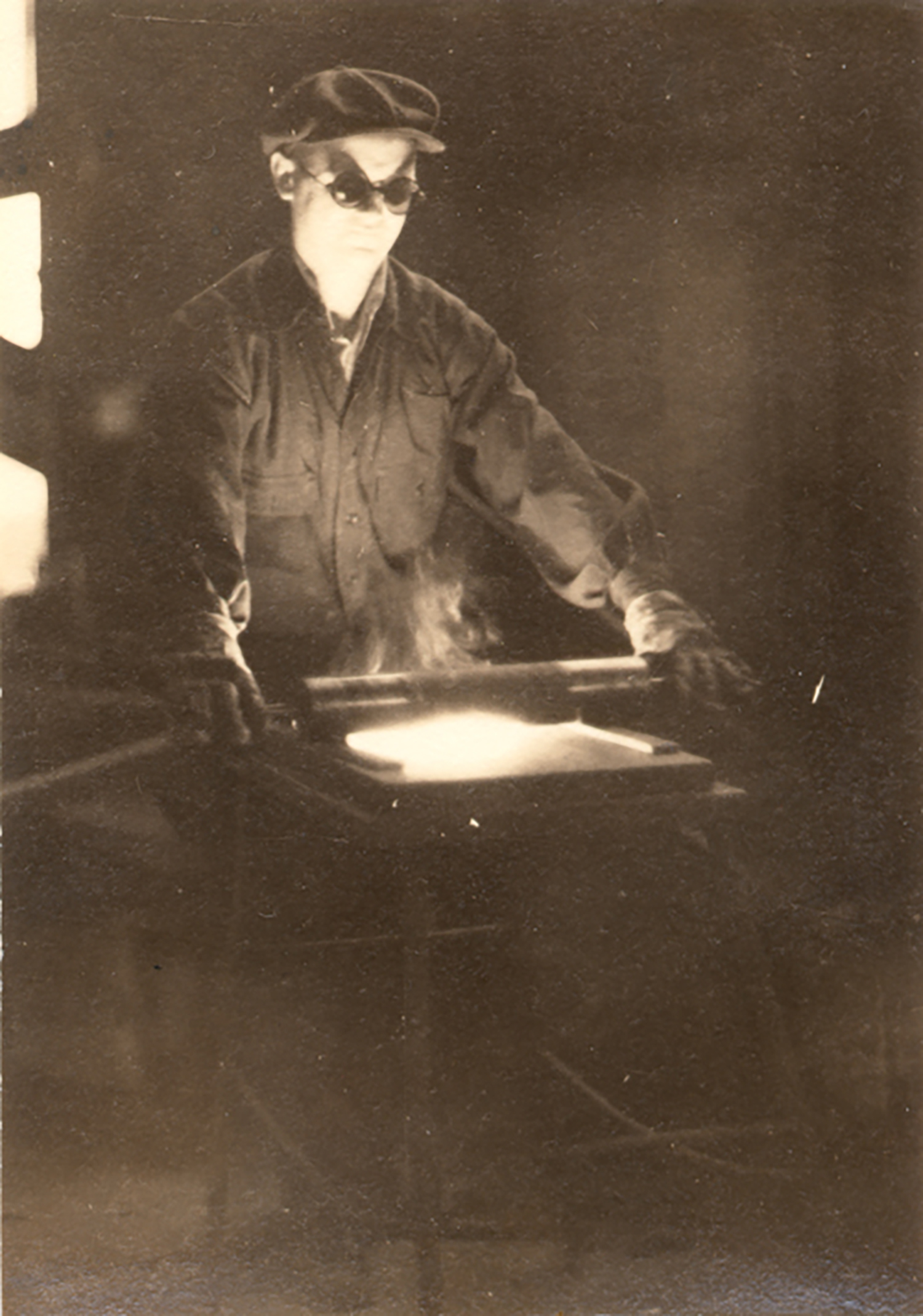 Figure 2: Ariel Gunther rolling out mosaic glass on a marver.