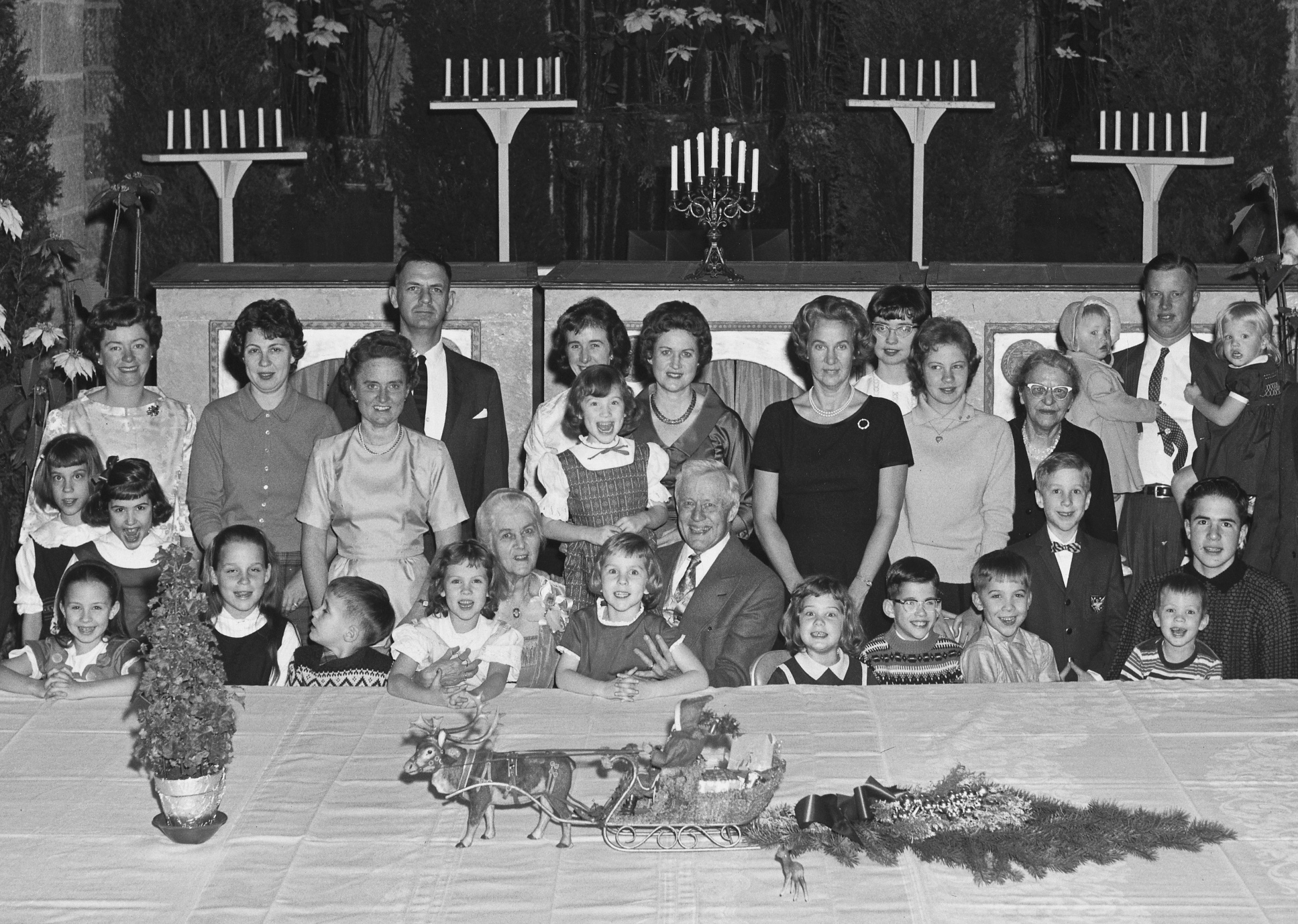 Raymond and Mildred Pitcairn pose with children and grandchildren on Christmas Day (1961) in Glencairn’s Upper Hall. Santa and his reindeer are the centerpiece of the holiday table.