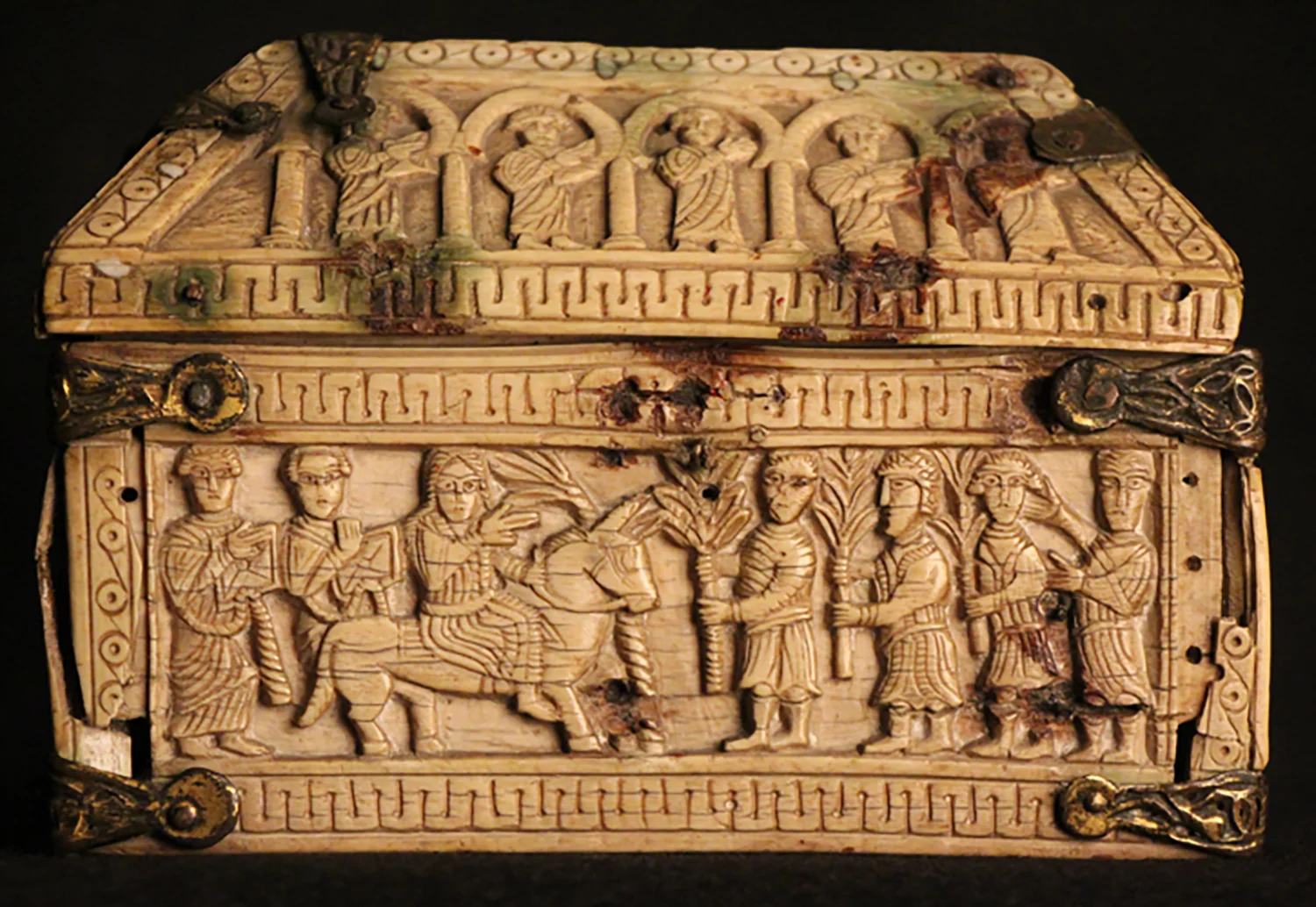 Figure 4: Scene on one of the long sides of the box depicting Solomon riding to Gihon to be anointed. He is greeted by men carrying palms.