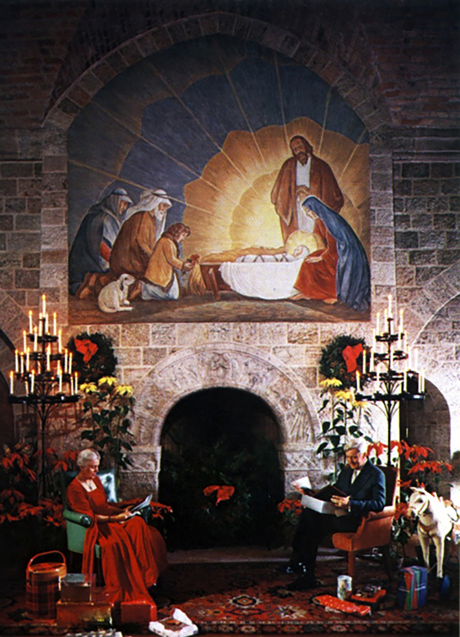 Mildred and Raymond Pitcairn pose for their 1954 Christmas card beside the "Seven Days of Creation" fireplace in Glencairn's Upper Hall. A large oil painting of the shepherds visiting the Christ Child hangs above the fireplace.