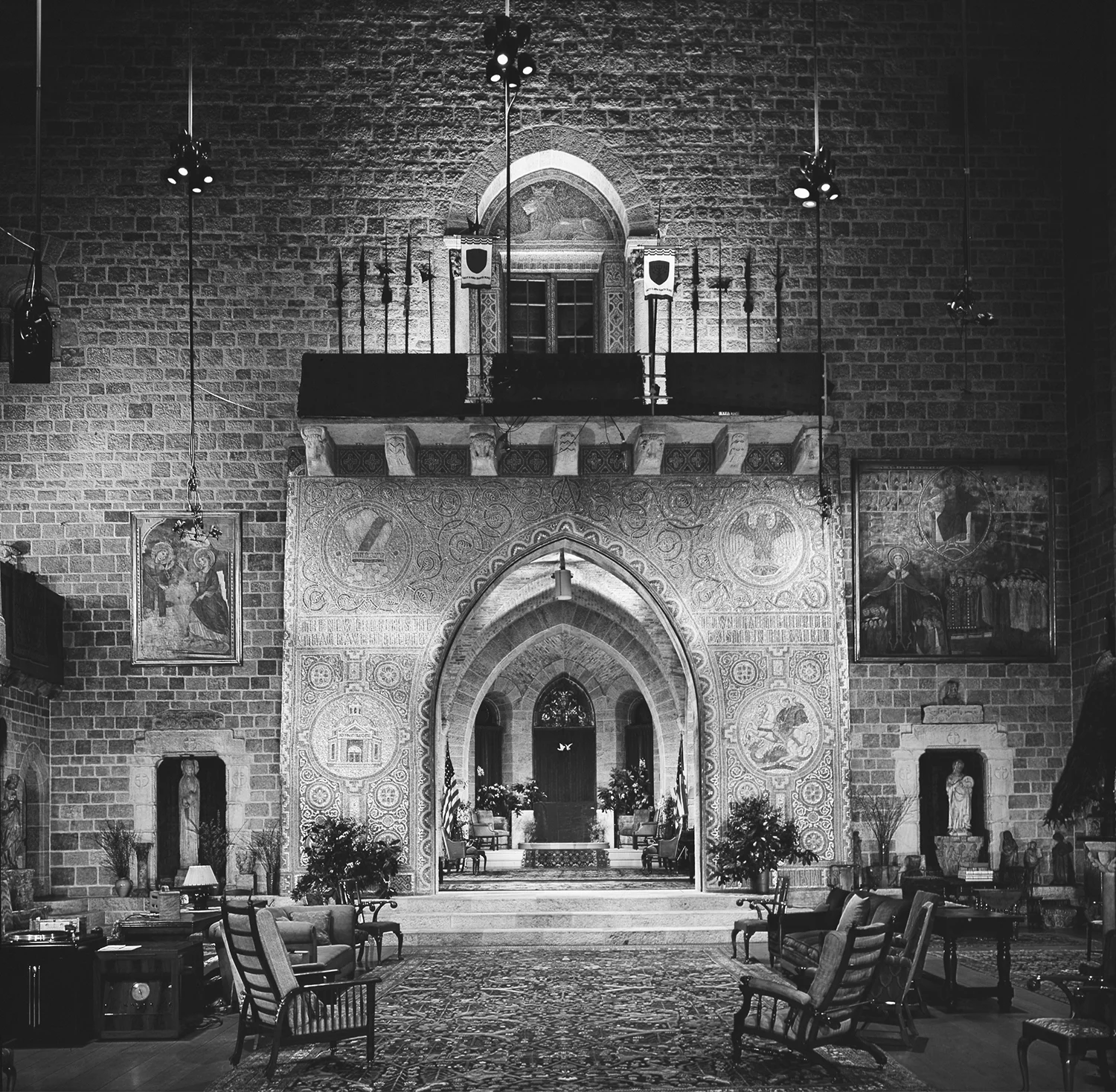 Figure 18: The Great Hall of Glencairn, with the large archway decorated with the Academy seal, sometimes served as a classroom. It was in this space that Raymond Pitcairn taught a series of music appreciation classes for college students. The room was equipped with a state-of-the-art sound system (lower left).
