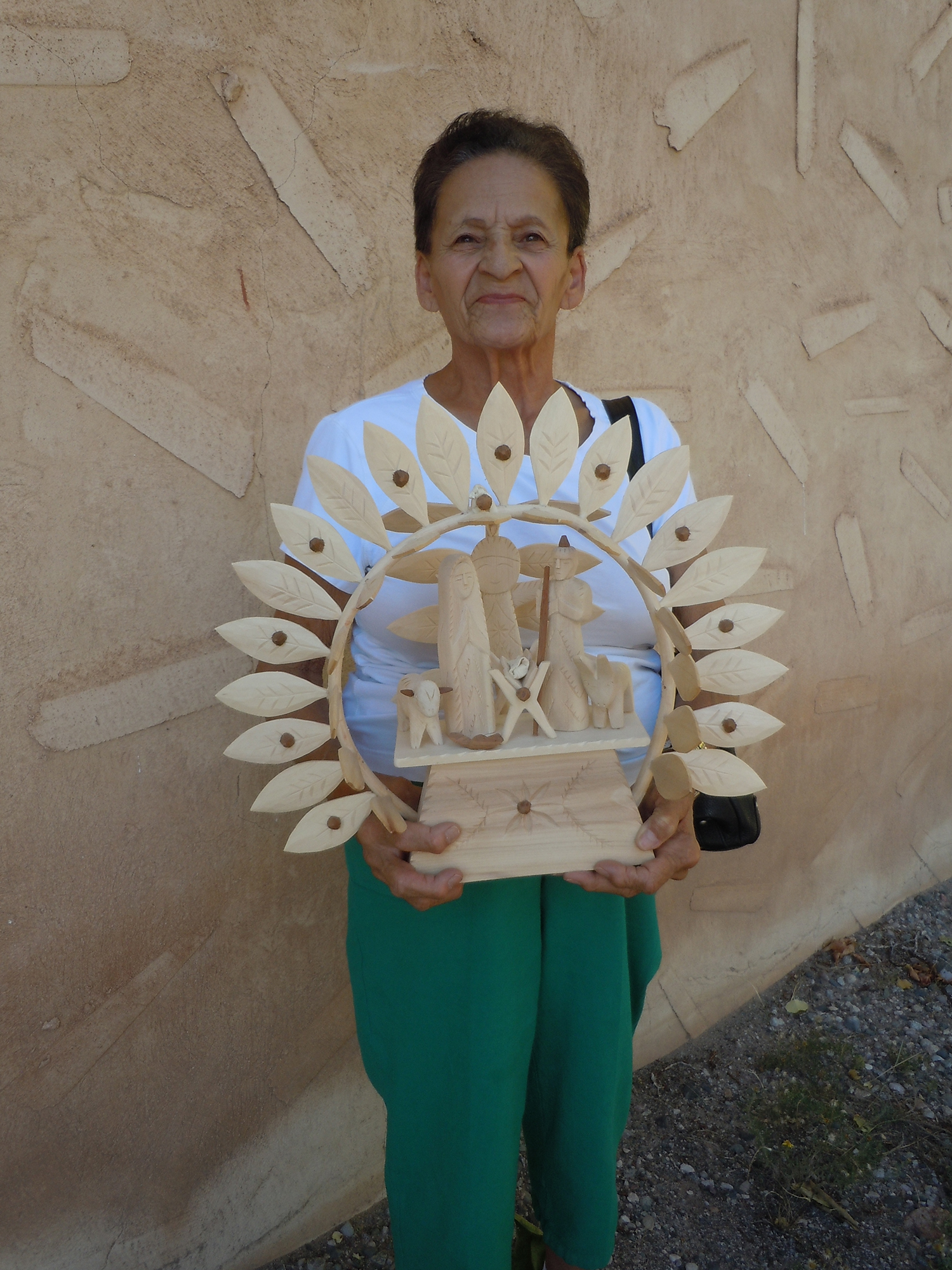 Figure 15: Sabinita López Ortiz, Córdova, New Mexico, poses with her Nativity santo pictured in Figure 14. Made in 2018. Photo courtesy of El Potrero Trading Post.