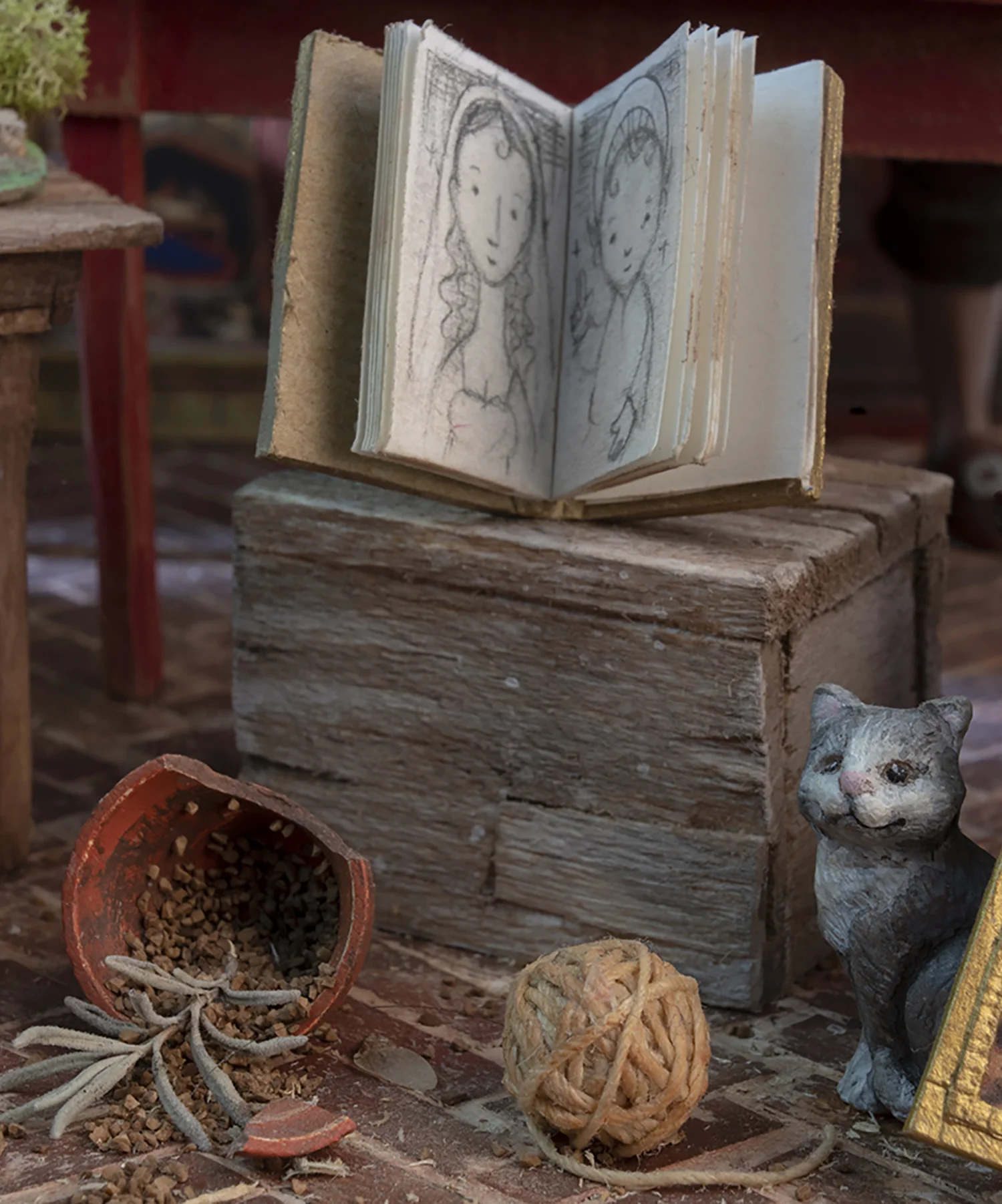 Figure 17: A cat, a ball of string, and a broken flower pot.