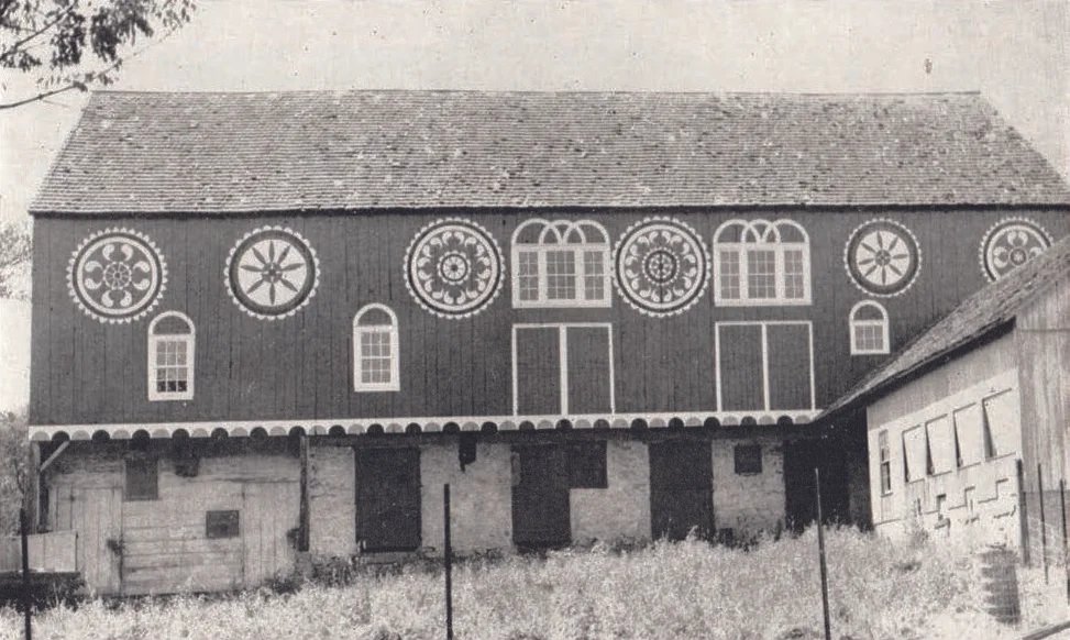 Figure 12: Historic Bucks County Barn, Photograph by Guy F. Reinert, ca. 1950, Pennsylvania German Cultural Heritage Center, Kutztown University. This barn once stood in Bucks County, near the border with Lehigh and Montgomery, and was painted by the prolific Noah Weiss (1842-1907), a hotel proprietor, wood carver, and folk artist of the Lehigh Valley. Weiss had no formal training, but was a master carver and painter, producing religious scenes of biblical stories for the walls of his hotel. He was also an innovative designer whose elaborate barn stars featured intricate raindrop patterns in radial formations that have become classic in the Lehigh Valley.