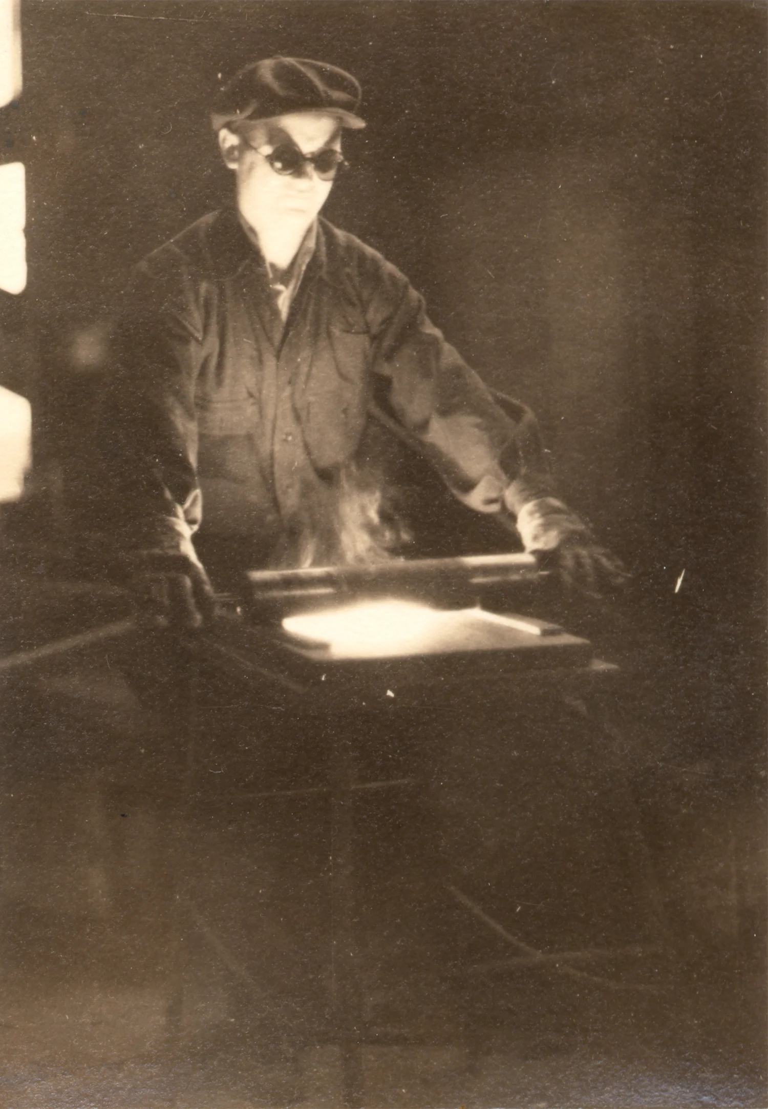 Figure 4: Ariel Gunther rolls a “pancake” of mosaic glass onto the marver between two metal bars. The height of the bars controlled the thickness of the glass tesserae.