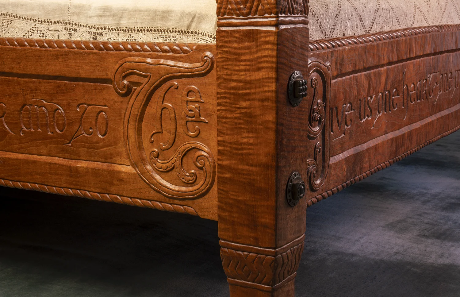 Figure 19: A corner of the master bed showing the intricate carving of the quotation around three sides.