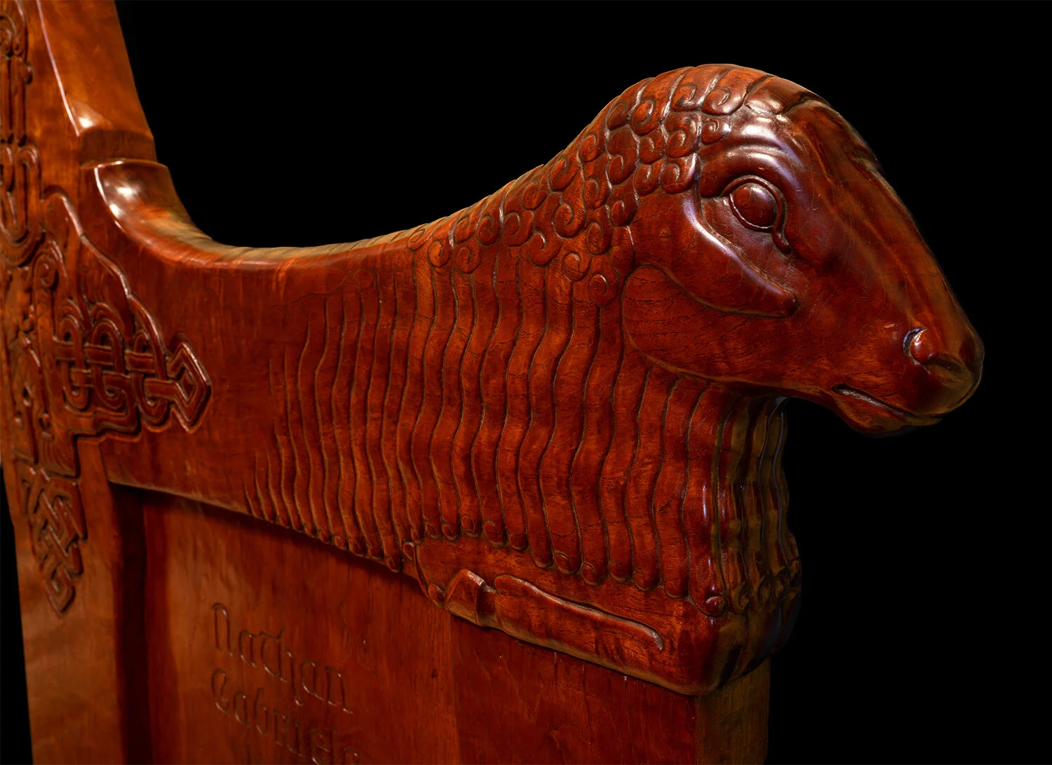 Figure 10: A carved ewe armrest on one of the inglenook benches.