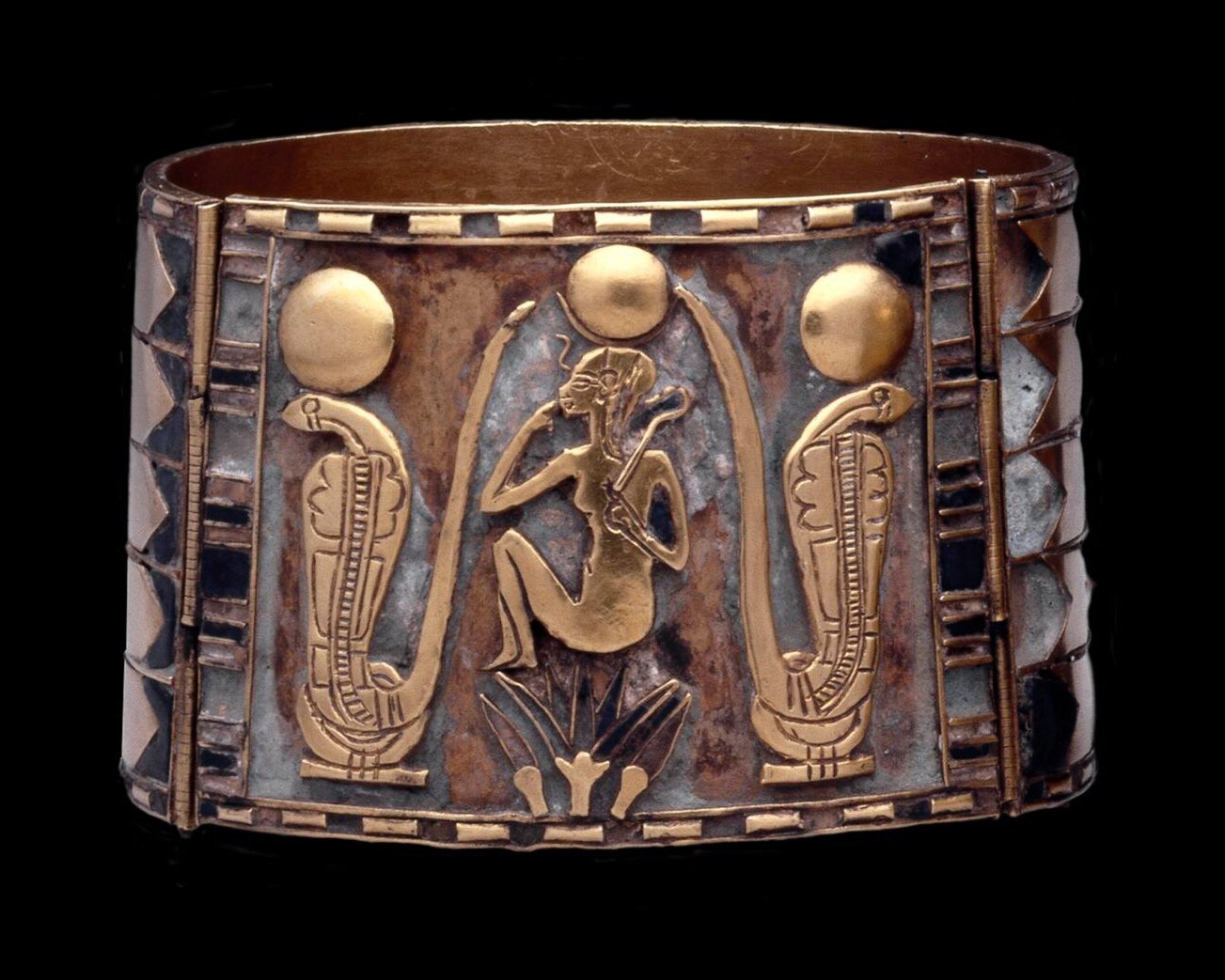 Figure 8.&nbsp;On this bracelet of Nimlot, the newborn sun god is shown as a child seated atop a lotus flower (EA14595). Image © The Trustees of the British Museum.