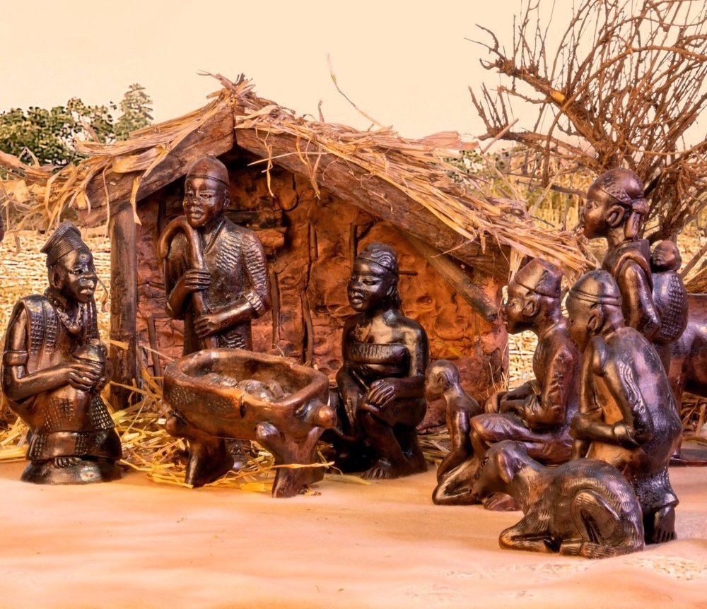  Nativity from the Republic of Cameroon. The 17 hand-formed clay pieces are fired, then glazed with a dark, bronze-like patina. The animals include a sheep, camels, and distinctive zebu cattle. 