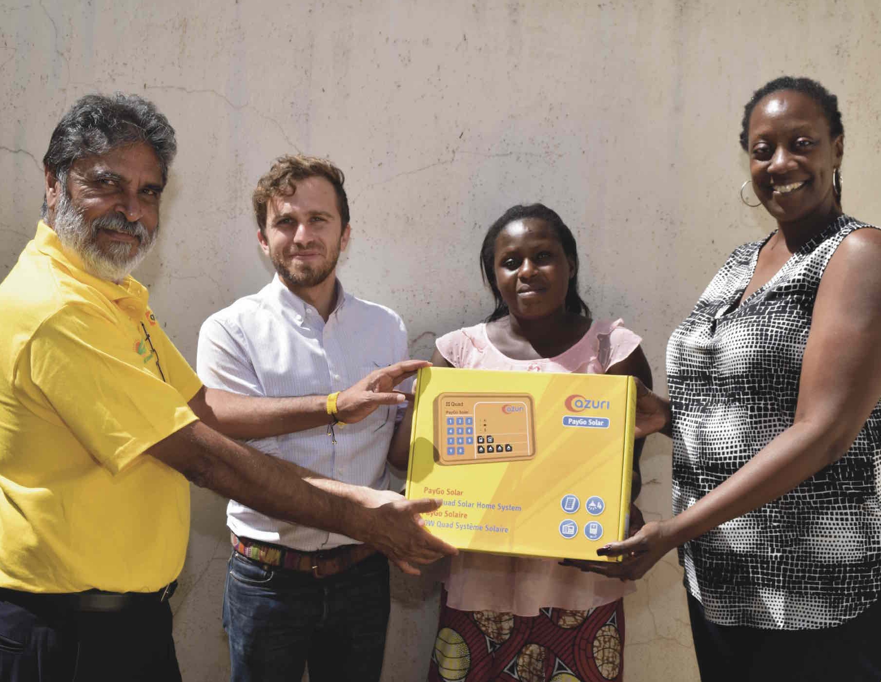 Photo: Raju Haria, CEO of Raj Ushanga House (left), Daniel Goldfarb, CEO of Lendable (second from left), and Sharon Arungu-Olende, head of East Africa for Lendable (right), provide a PAYGo solar system to a customer.