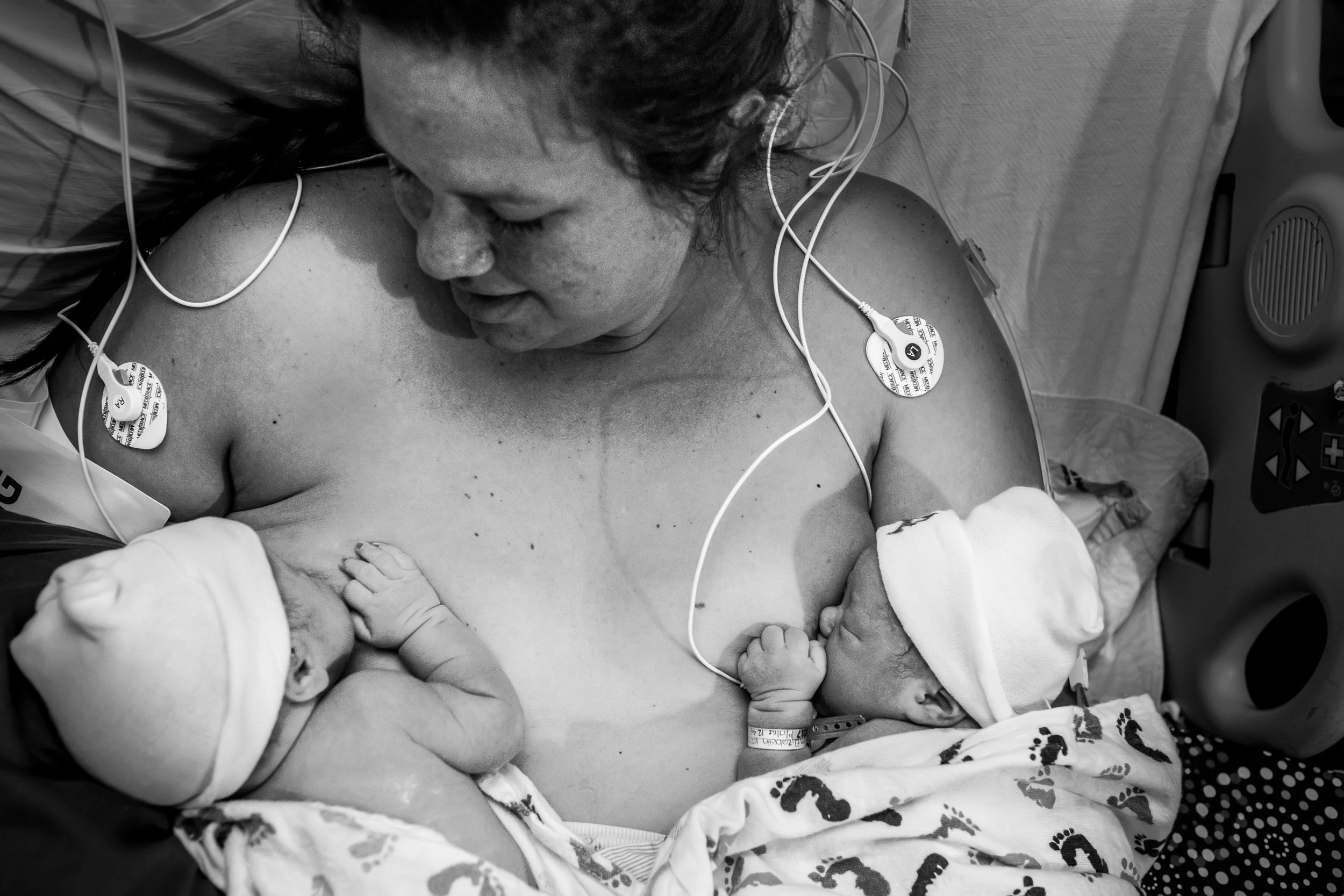 mom breastfeeding twins after birth
