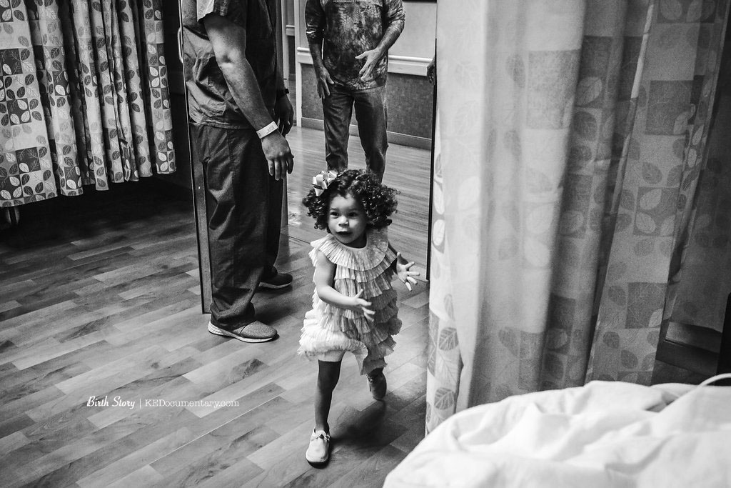 running to meet her new baby sister
