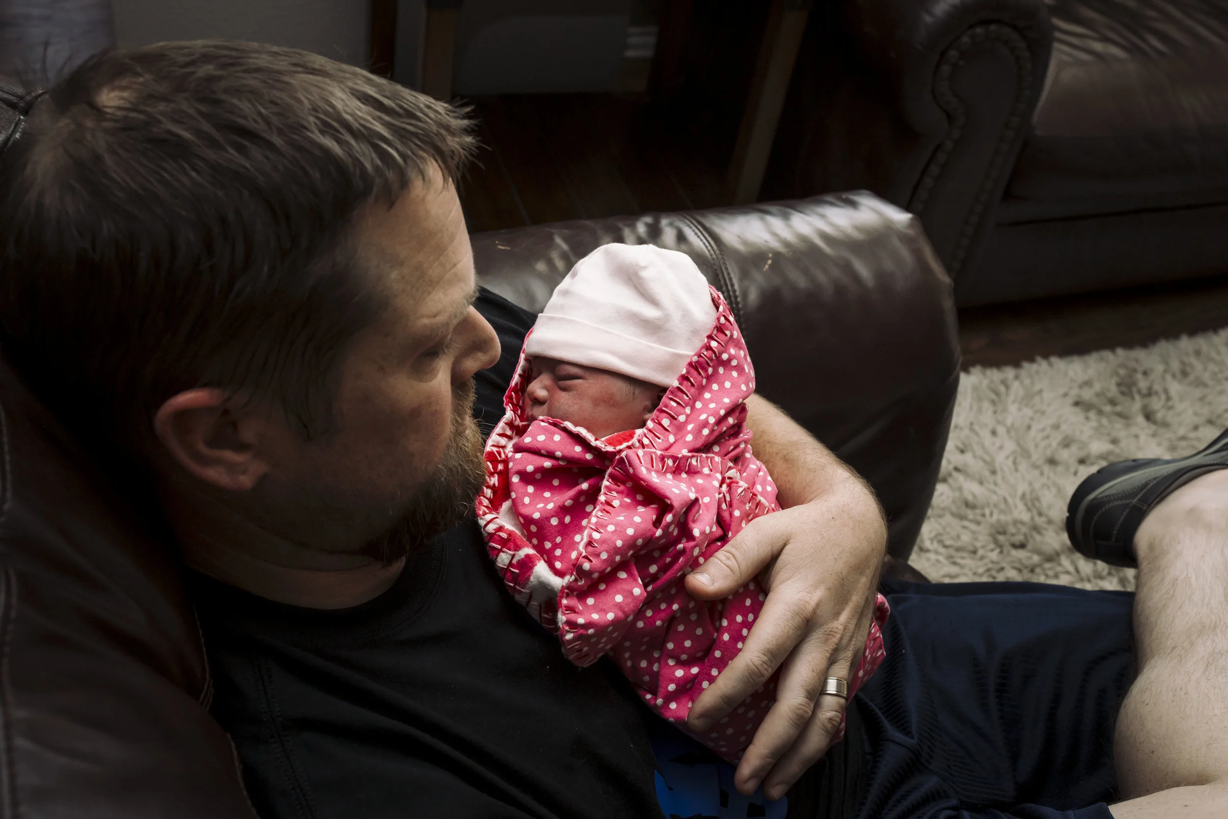 dad snuggles after birth of baby girl