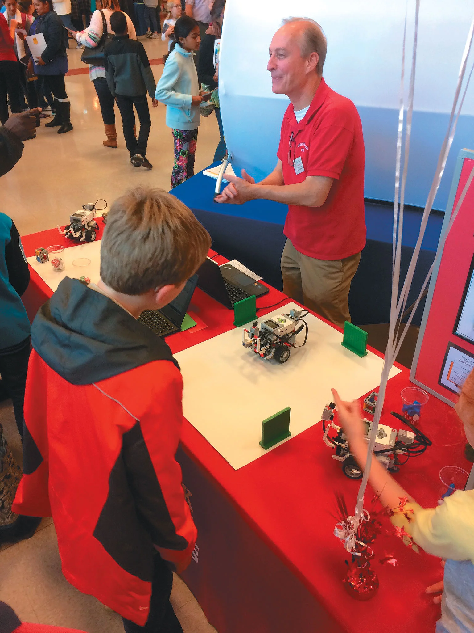 reedy creek magnet middle school mechatronics teacher ron boehm speaks to students at the magnet, early college, and year round schools fair at southeast raleigh magnet high school. Photo by thomas cooper/christine sachs