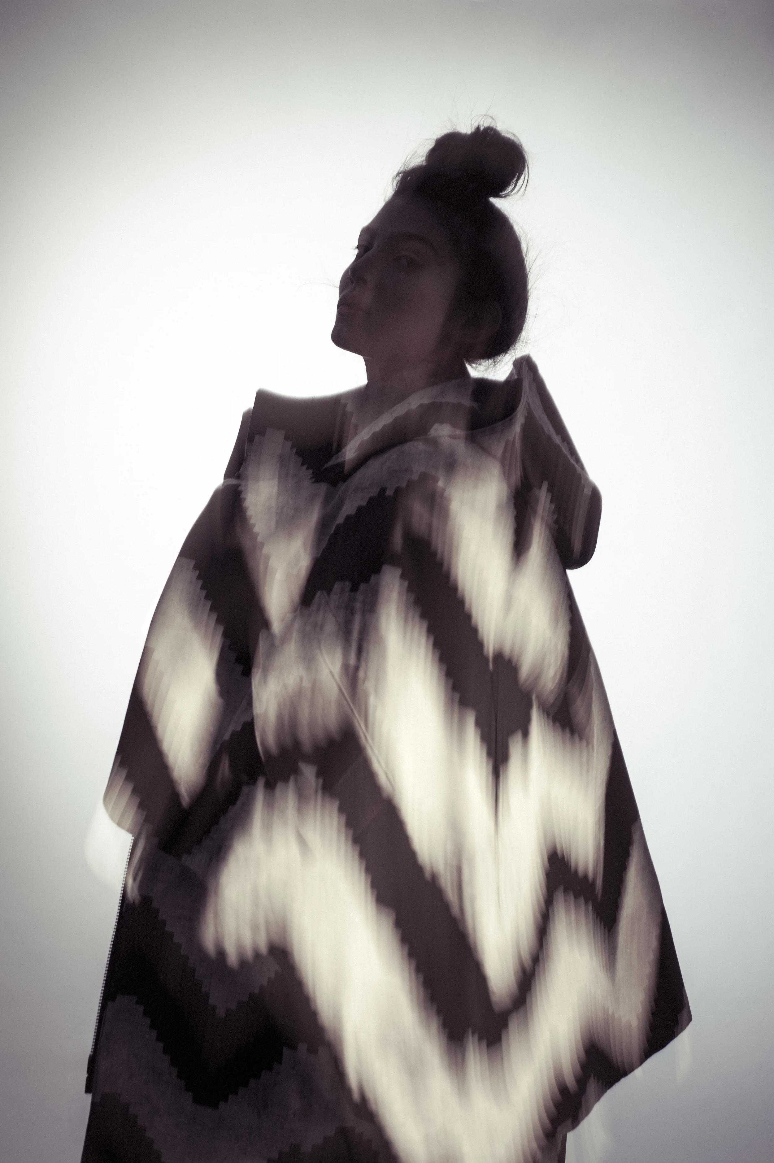 Coat and dress by Mingyu Du, MFA Fashion Design and Joseph Khawane, MFA Textile Design. Shoes, Aldo. 