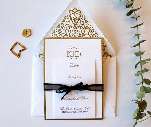 The Monogram A simple gold foil monogram, surrounded in a gold border, paired with black letterpress. Shown here with a gold, patterned envelope liner, and digital gold enclosure cards. Suite can be customized in your colors, and is also available in one color foil or letterpress printing, printed in digital gold as part of our Standard Suite, or paired with a pocketfold for our Couture Suite.