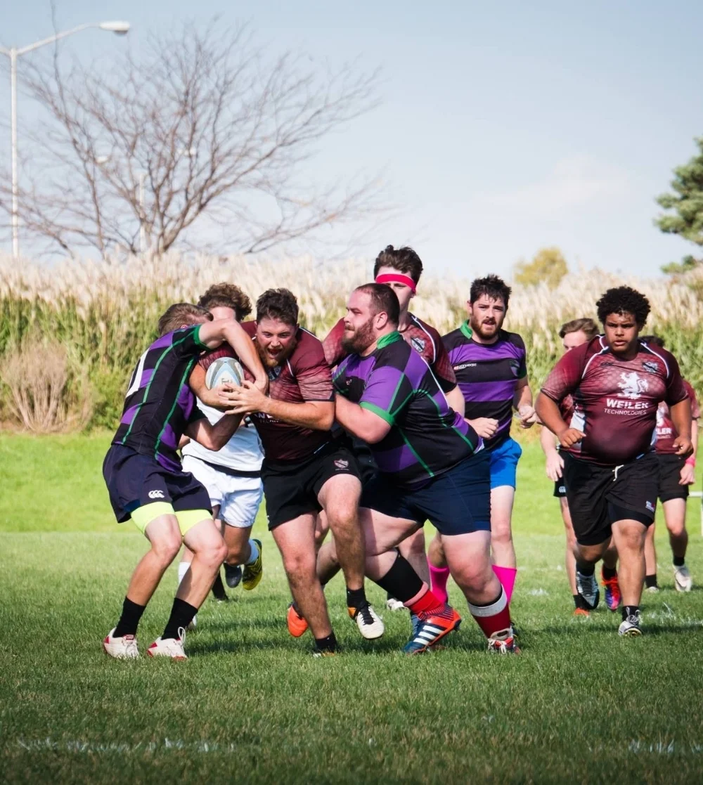 Ducks Captain Ty Carew fights to keep possession against Muddy River on Oct. 21 at the University of Iowa Rugby Fields.