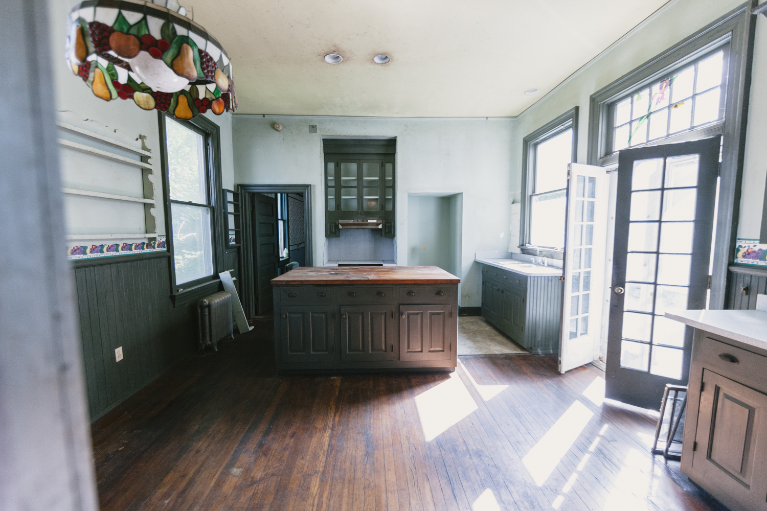 The kitchen features an historic island, once used as a lab table in Randolph Macon Womens college and opens up onto the back porch. 