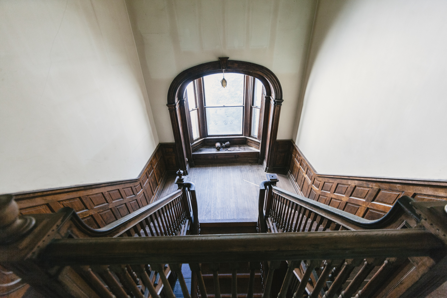 The split staircase down to the window seat overlooking the back garden then uniting to enter the foyer