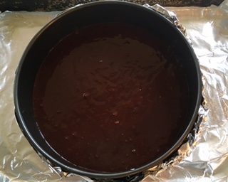 It is important to wrap the bottom of the springform pan with foil. This torte cooks best in a water bath, and this protects the finished product from water. Add a cup or so of water to bottom of baking sheet.