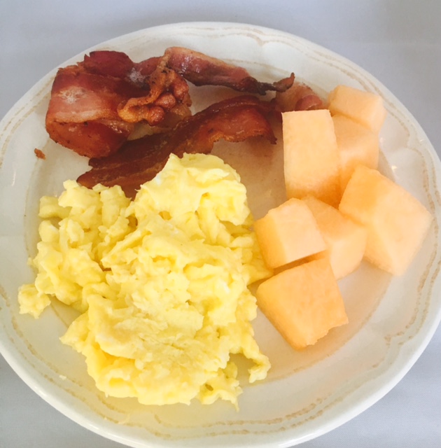 Farm fresh scrambled eggs, organic uncured bacon and fruit of choice