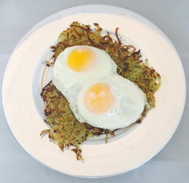 Eggs over easy with homemade potato fritters