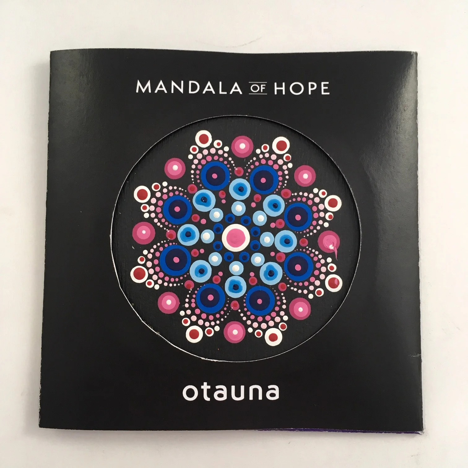 In the LOVE is all we need mandala, the blue dots represent a difficult time in one’s life. The pink dots encircle the blue, symbolizing the love that surrounds us when we need it most.