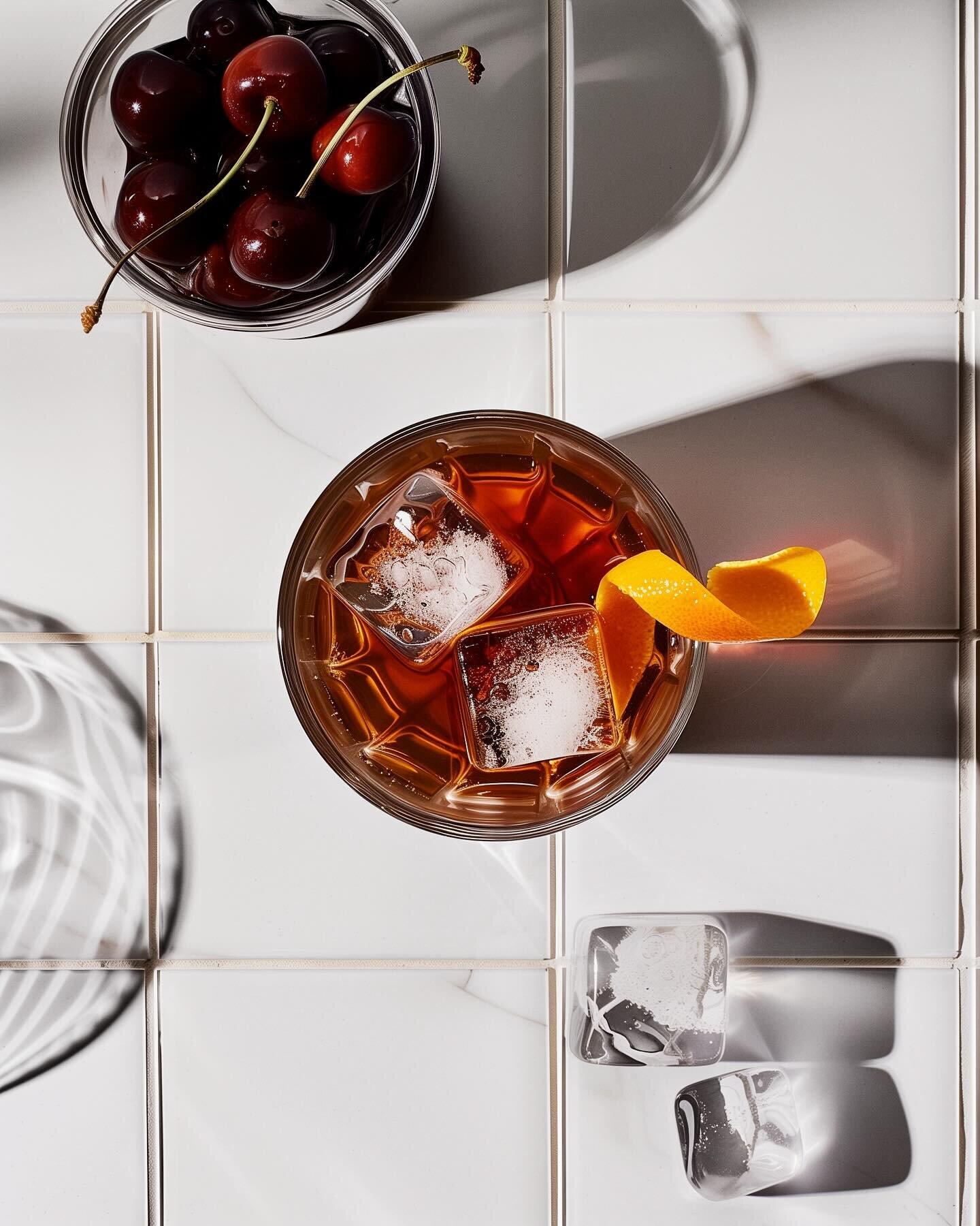 A symphony of rye, sugar, and bitters. Every detail matters when crafting the perfect Old Fashioned. #oldfashionedcocktail #brandiedcherries #foodphotography #cheers
