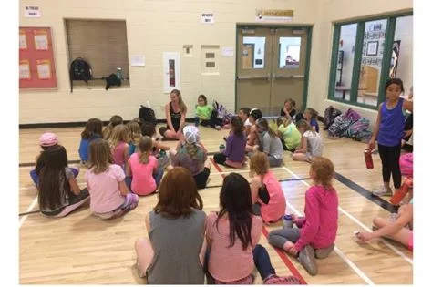 Kelsey speaking to a girl running group at a local school