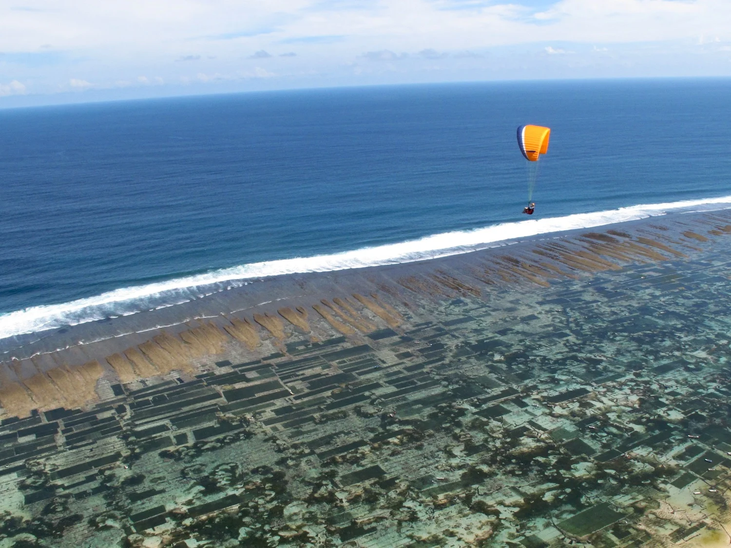 Tash flying at Timbis with seaweed farms below