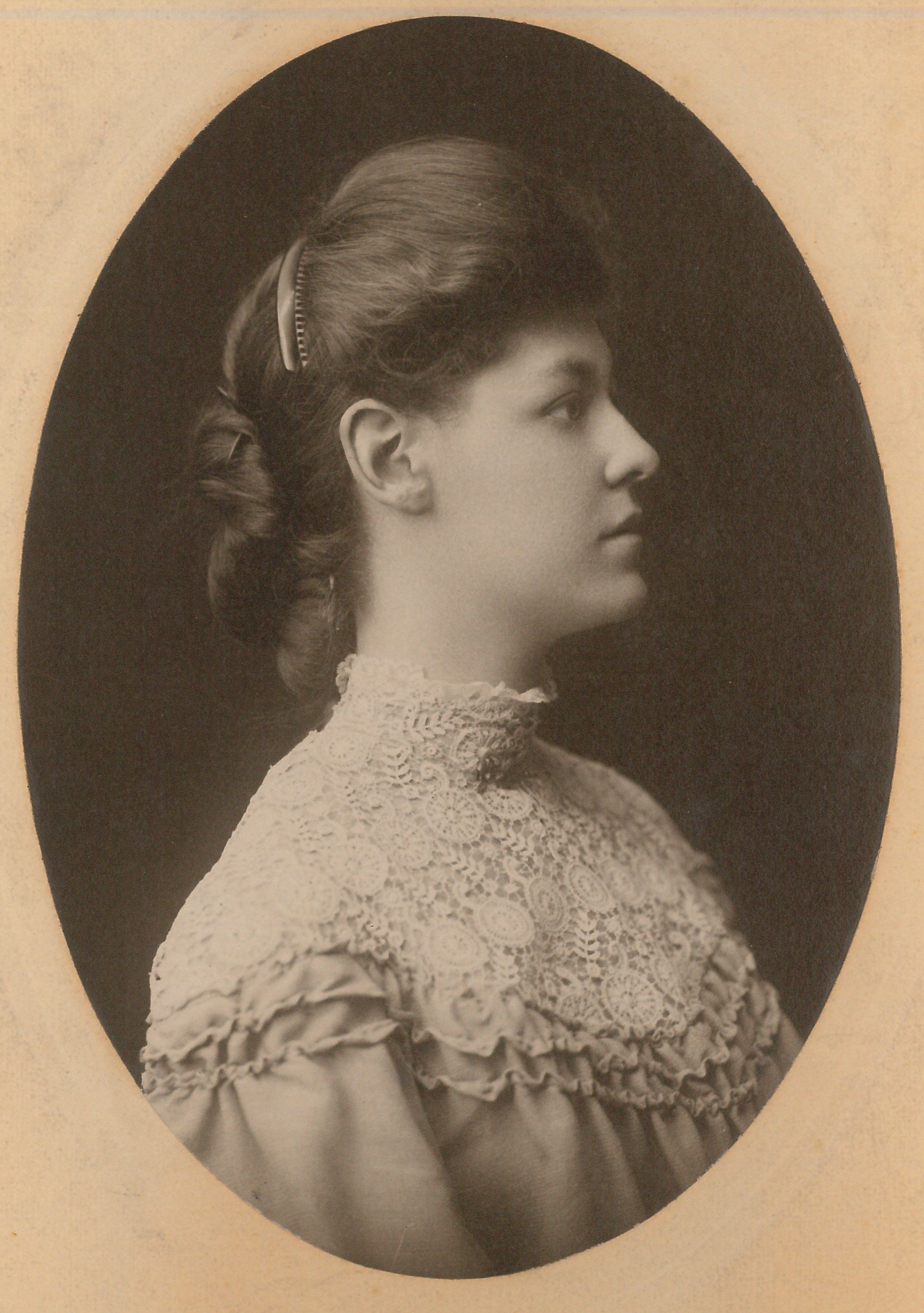 Black and white portrait of a young Beulah Cockayne, wearing a high-neck lace blouse, with her hair styled and pinned back.