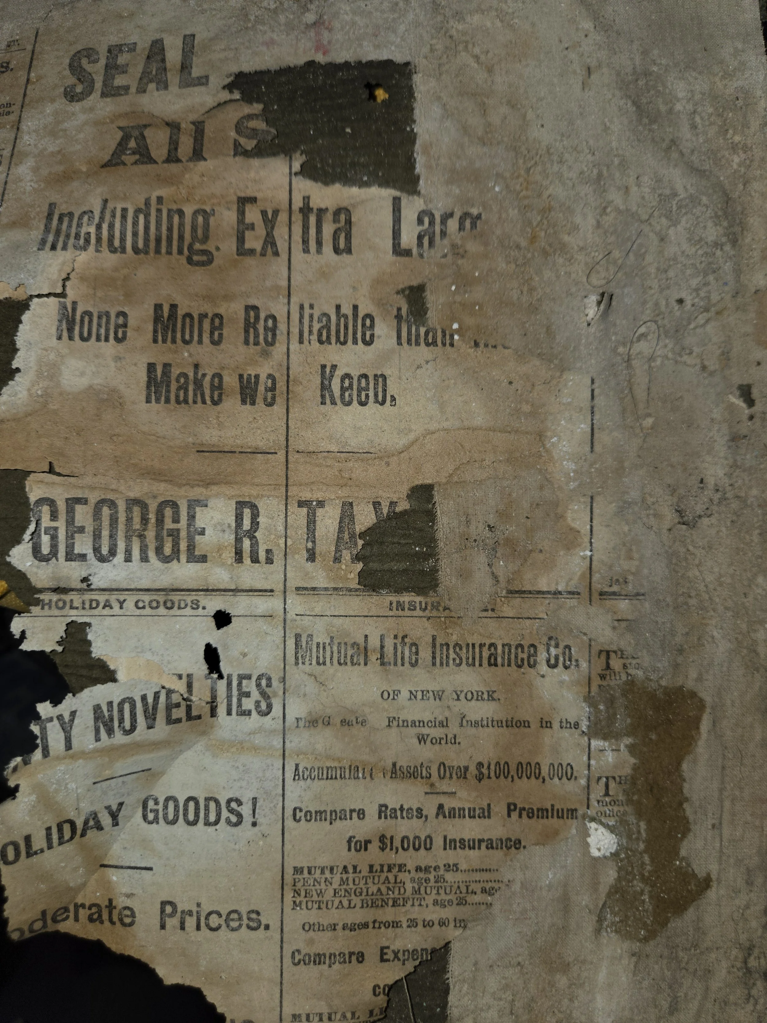 Old, torn, and faded newspaper or poster on a wall.
