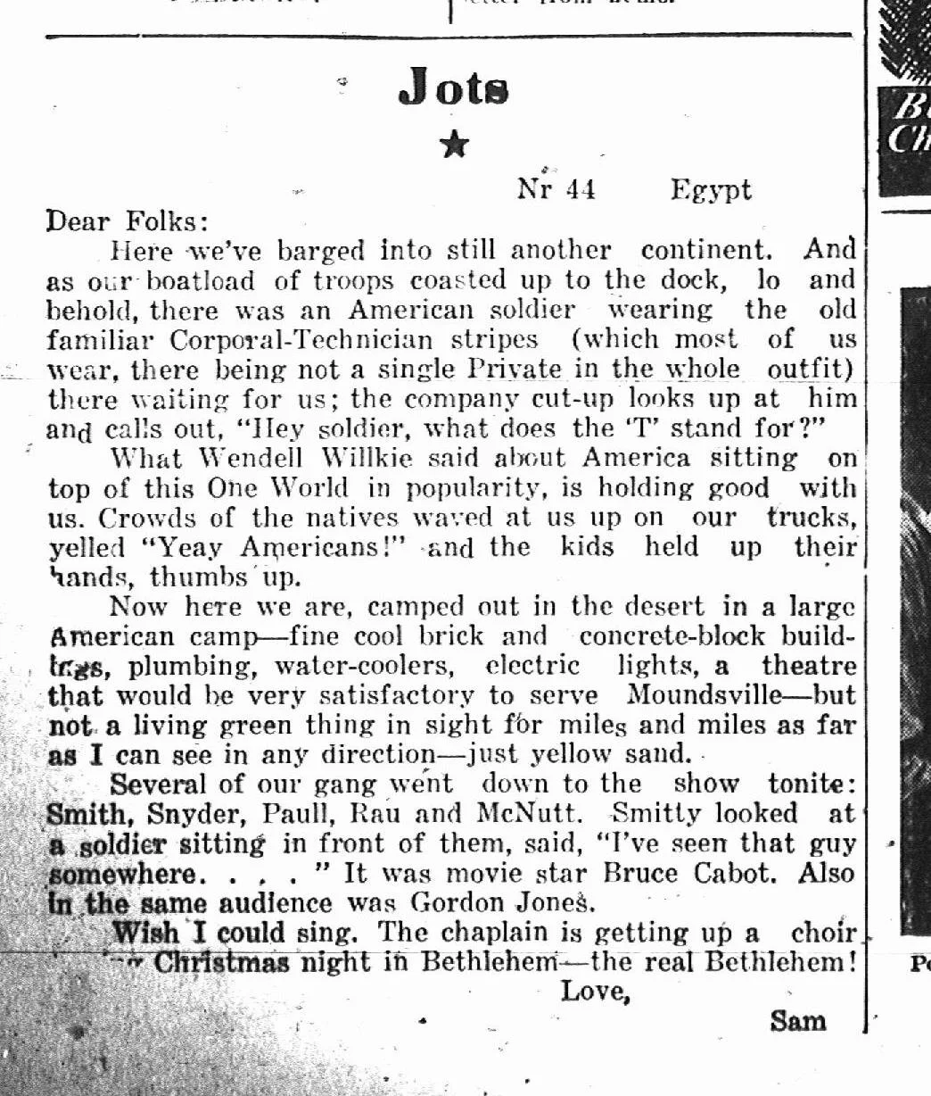 Clipping from a newspaper or magazine with a humorous story titled "Jots" about American soldiers in Egypt, describing their appearance, activities, and an interaction with natives, ending with a humorous note about singing Christmas carols in Bethlehem. The text is handwritten and includes references to military life, entertainment, and patriotism.