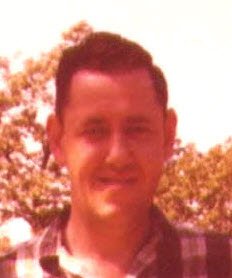 John Cockayne smiling outdoors with trees in the background.