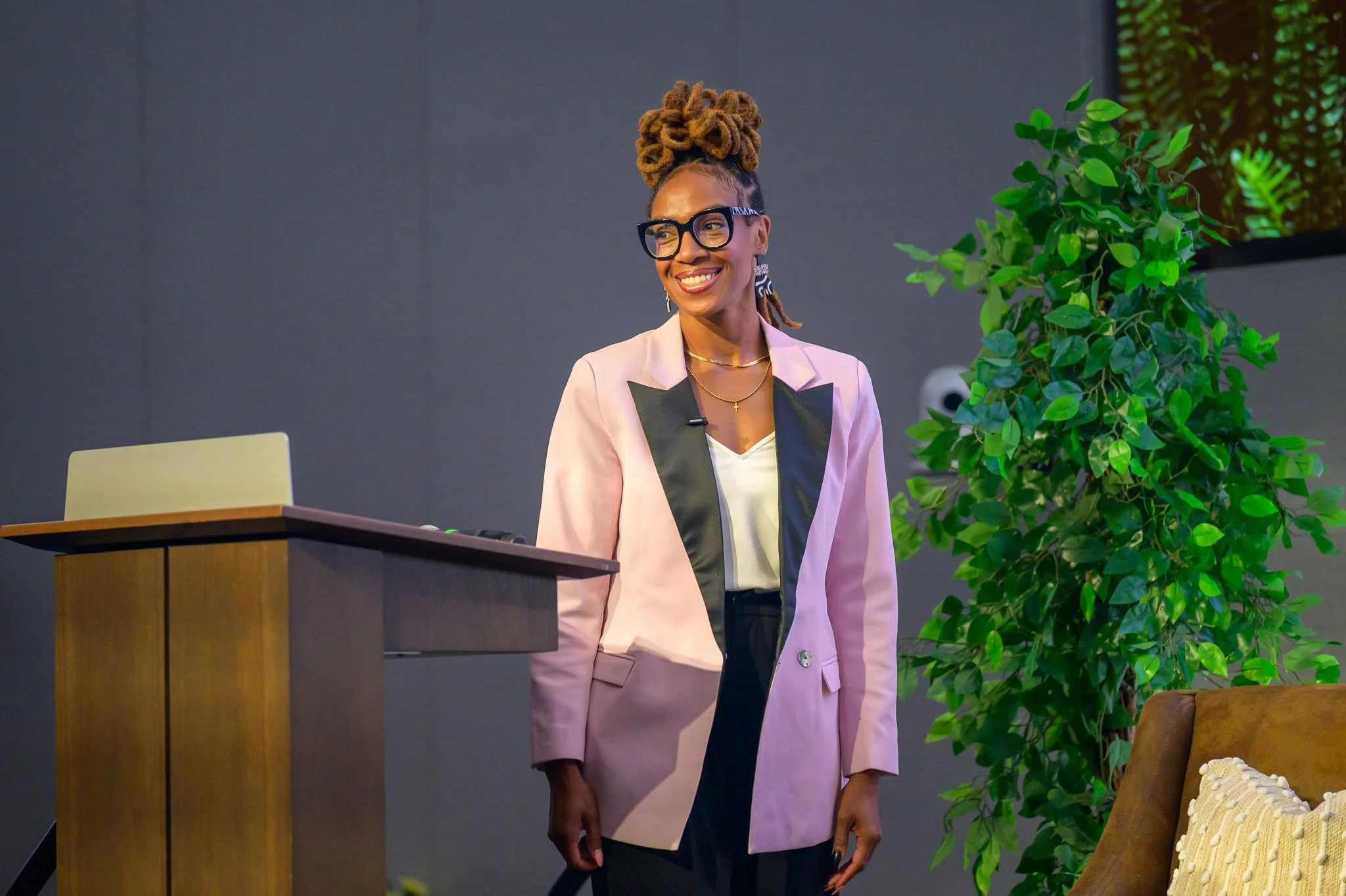 Professional speaker portrait captured during a live presentation at a corporate event, highlighting leadership and public speaking moments.