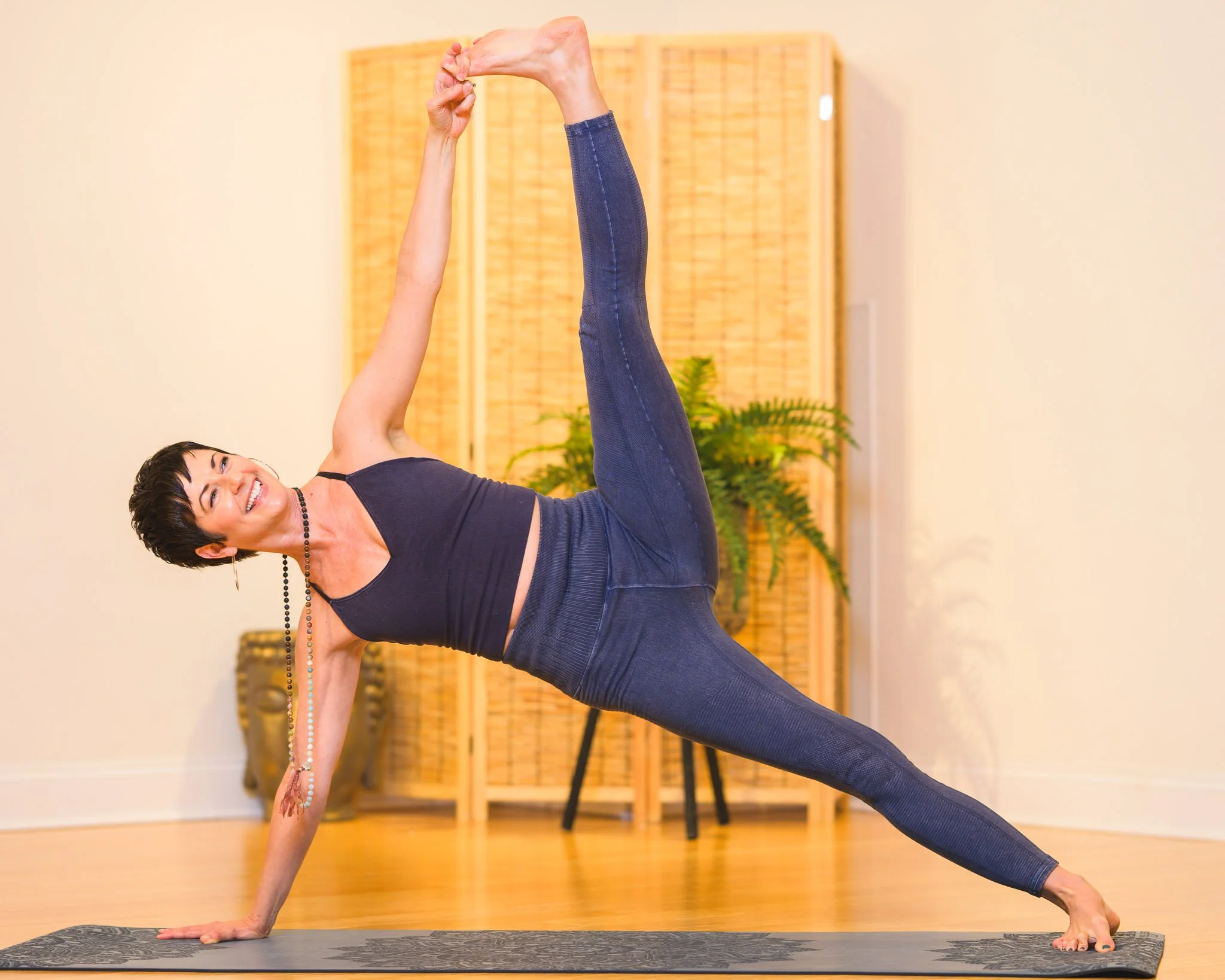 Lifestyle fitness portrait of a woman practicing yoga indoors, photographed with natural light and clean composition by Scott Photography.