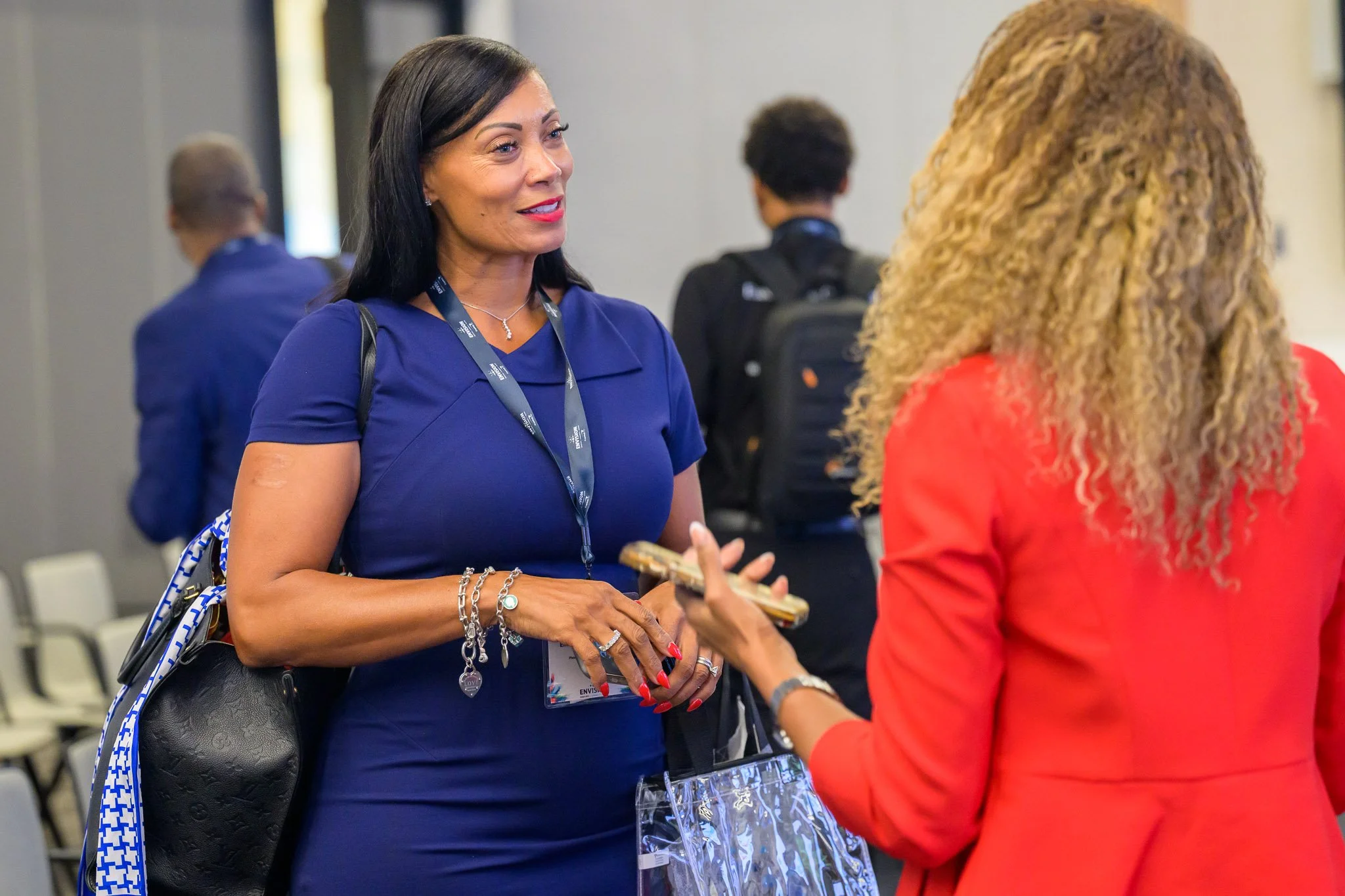 Attendees networking during a professional business conference, capturing authentic conversation and engagement in a corporate event setting.