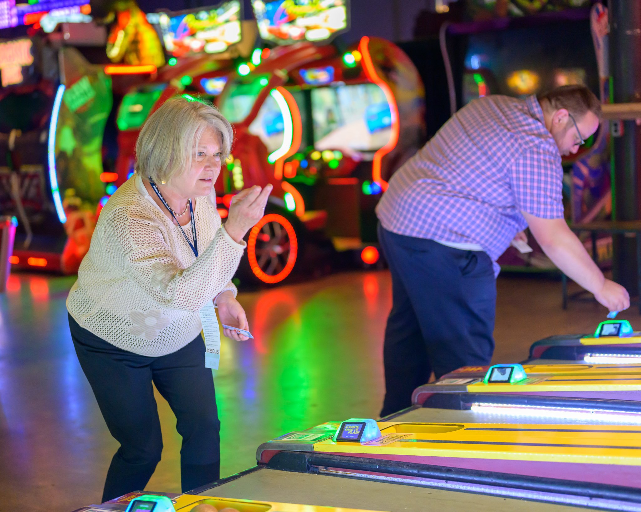 Conference attendees participating in interactive activities during a corporate event, showcasing candid moments and attendee engagement.