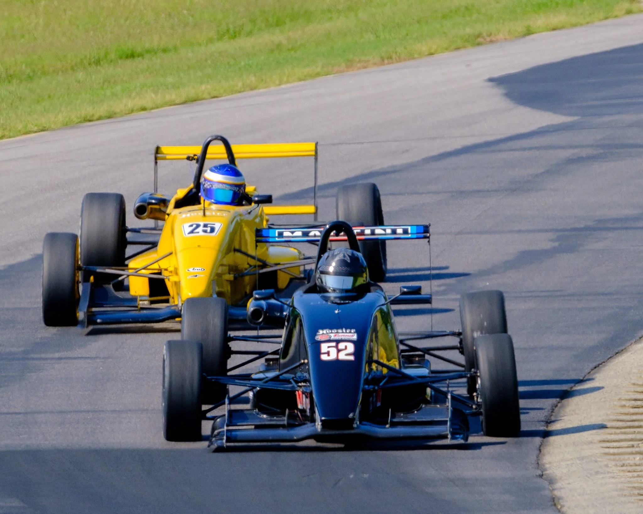 Open-wheel race cars competing on a road course, showcasing speed and precision motorsports photography by Scott Photography.