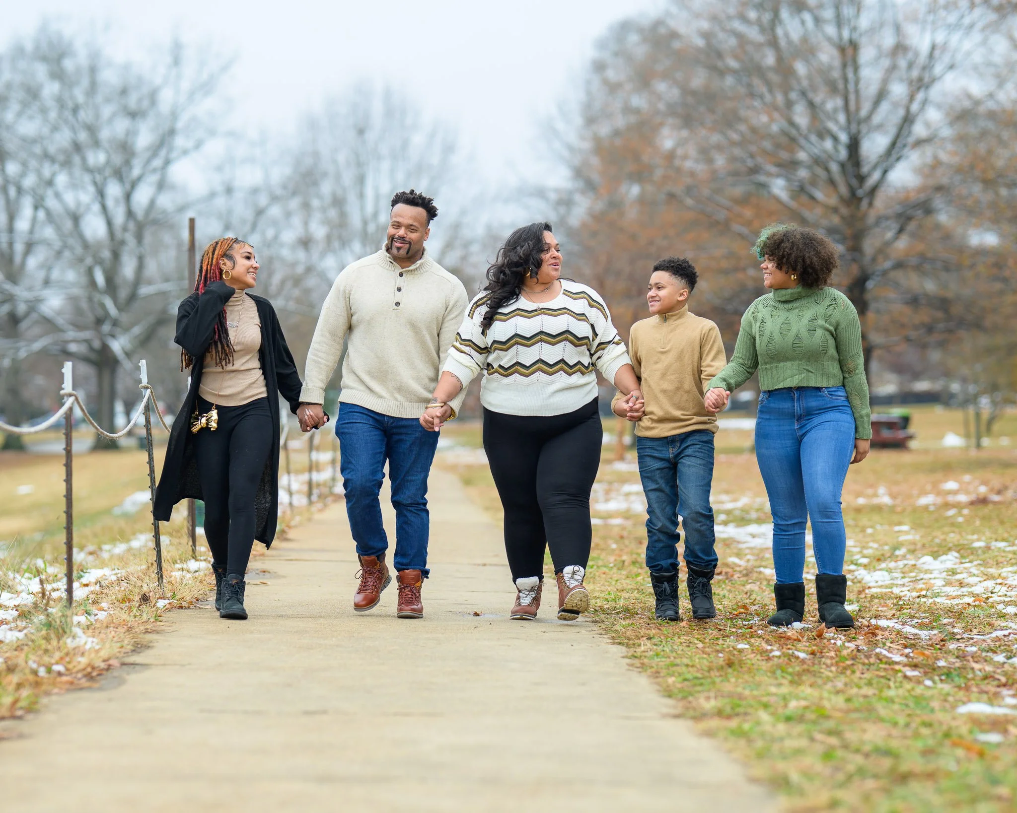Lifestyle family portrait of a diverse family walking together outdoors in Central Virginia, photographed by Scott Photography.