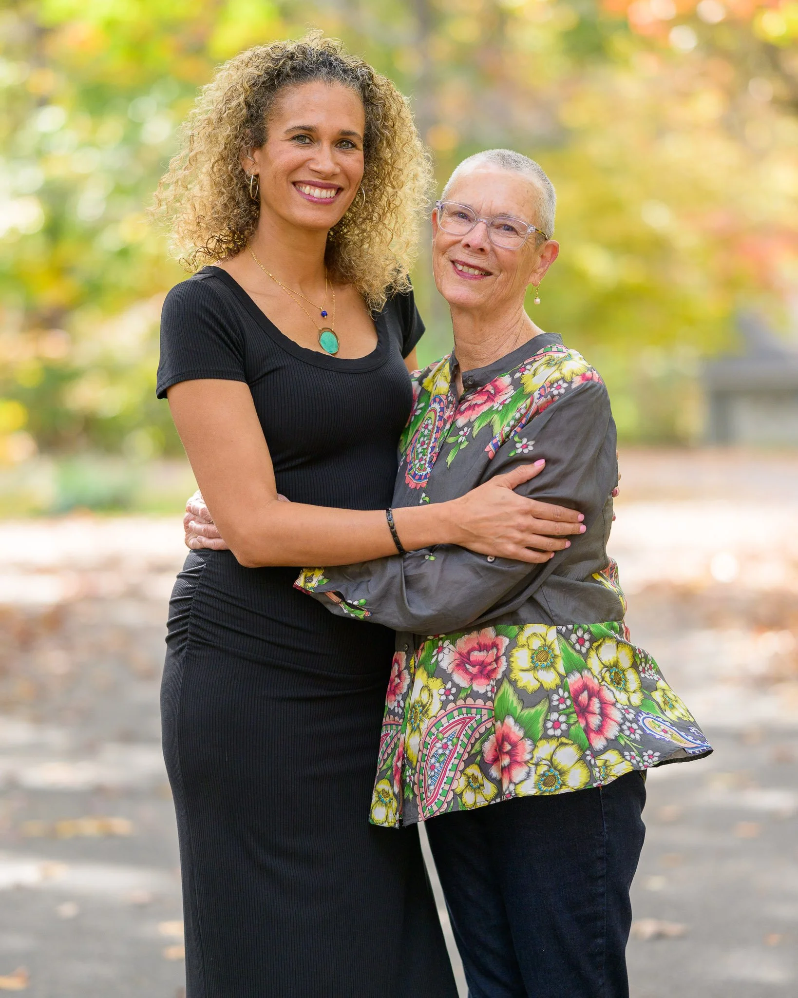 Lifestyle family portrait of a mother and adult daughter embracing outdoors during fall in Richmond, Virginia, photographed by Scott Photography.