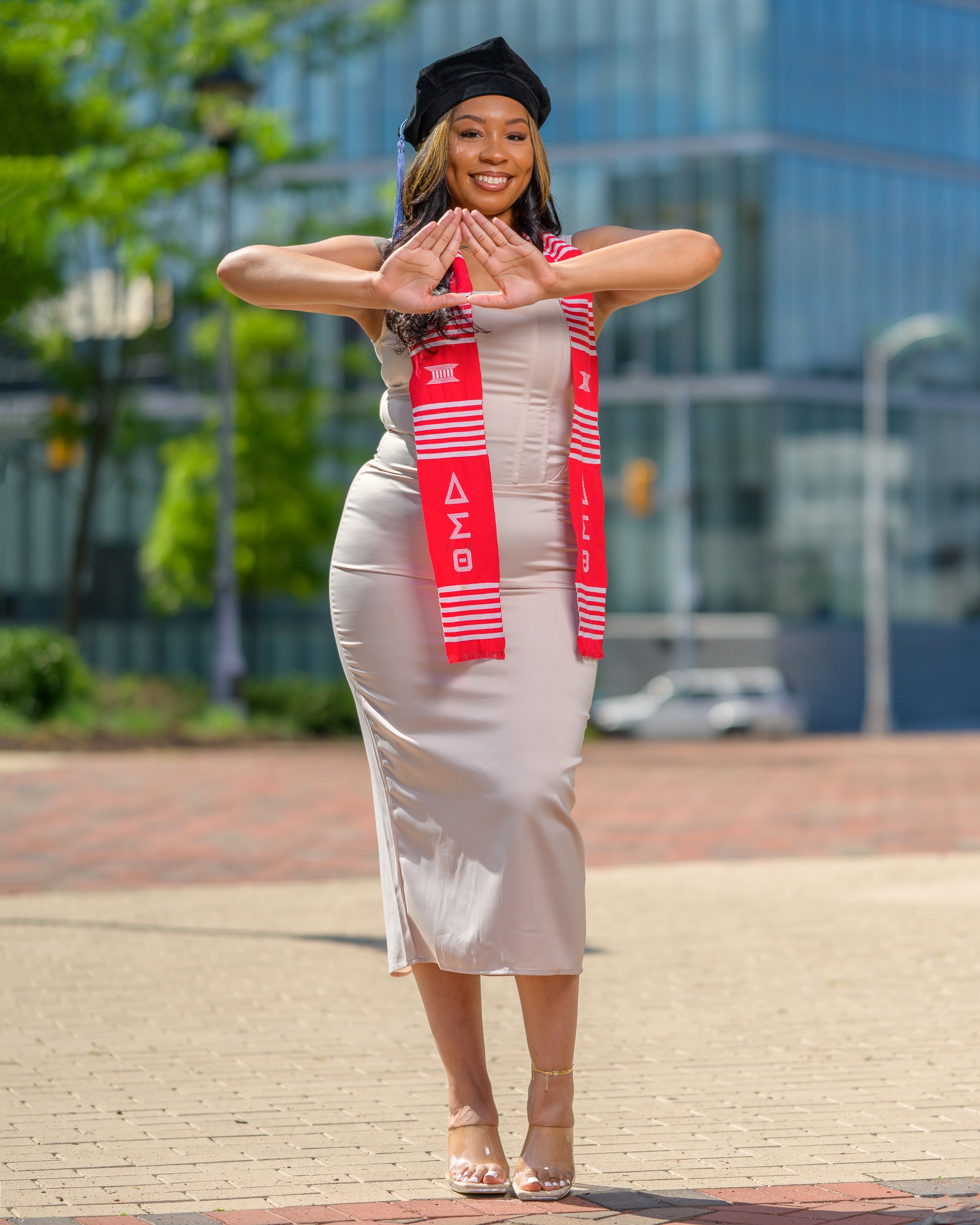 Graduation portrait of a college graduate wearing cap and stole in an urban setting, photographed in Richmond, Virginia by Scott Photography.