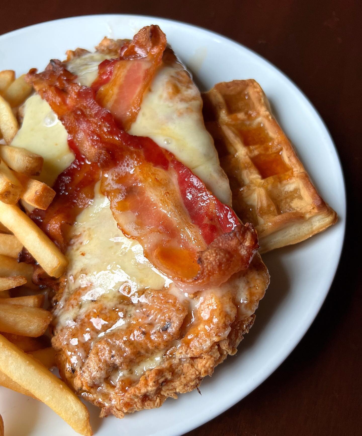 Suitable for breakfast, lunch, and dinner 🤤 on the specials this week FRIED CHICKEN &amp; WAFFLE seasoned fried chicken breast, bacon, cheddar cheese, waffle; hot honey drizzle, maple drizzle served with fries