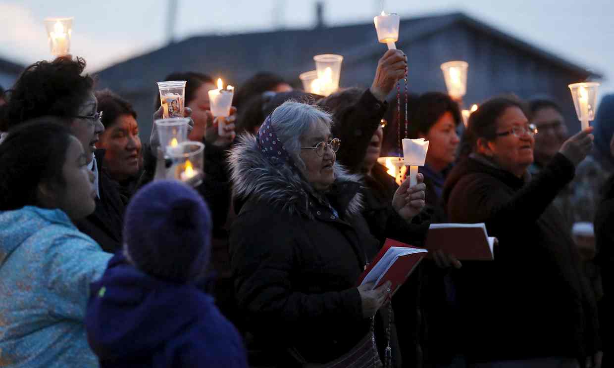 People take part in a candlelight vigil Attawapiskat. Photograph: Chris Wattie/Reuters